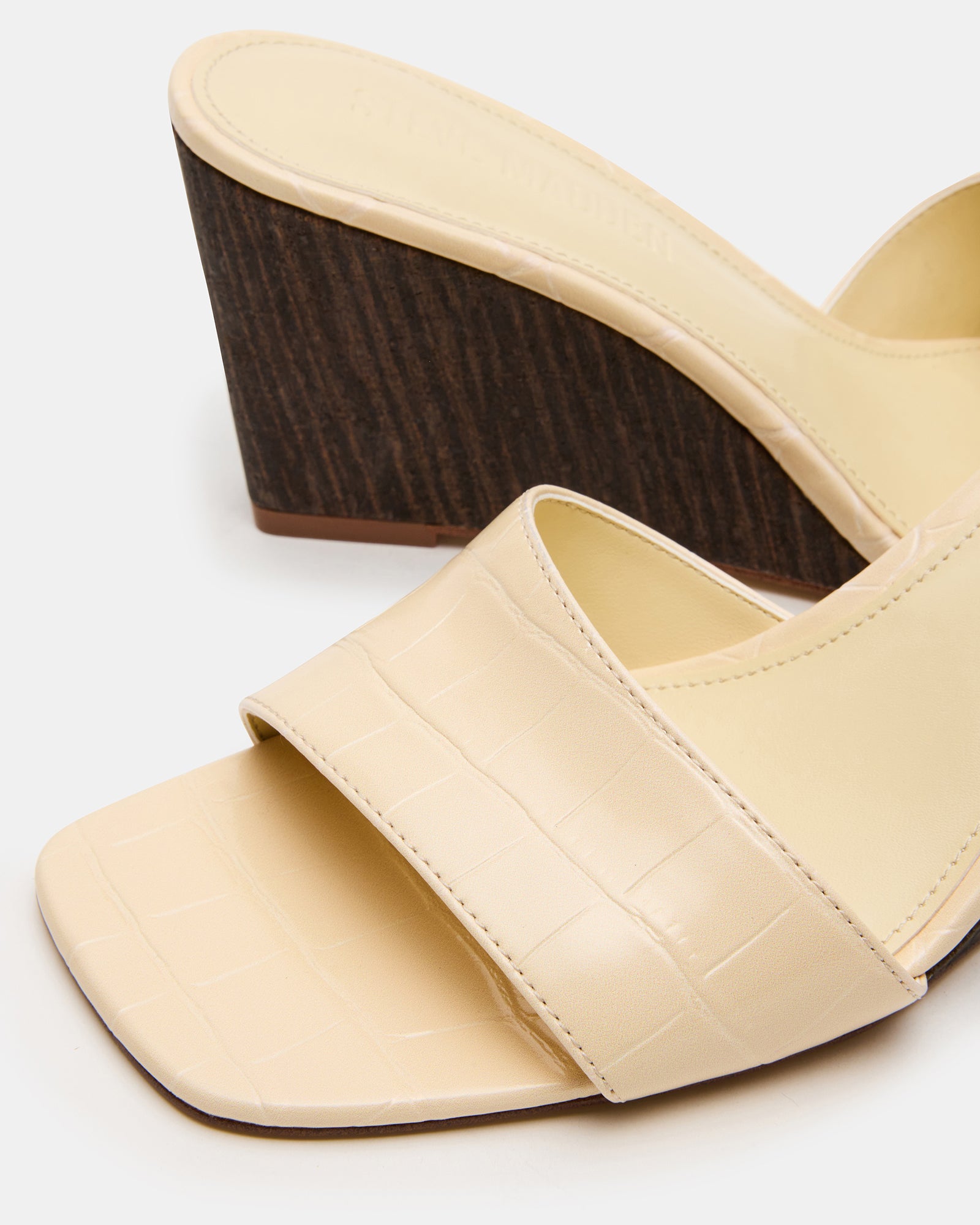 Wedge heel sandals white in a natural setting, ideal for casual wear.