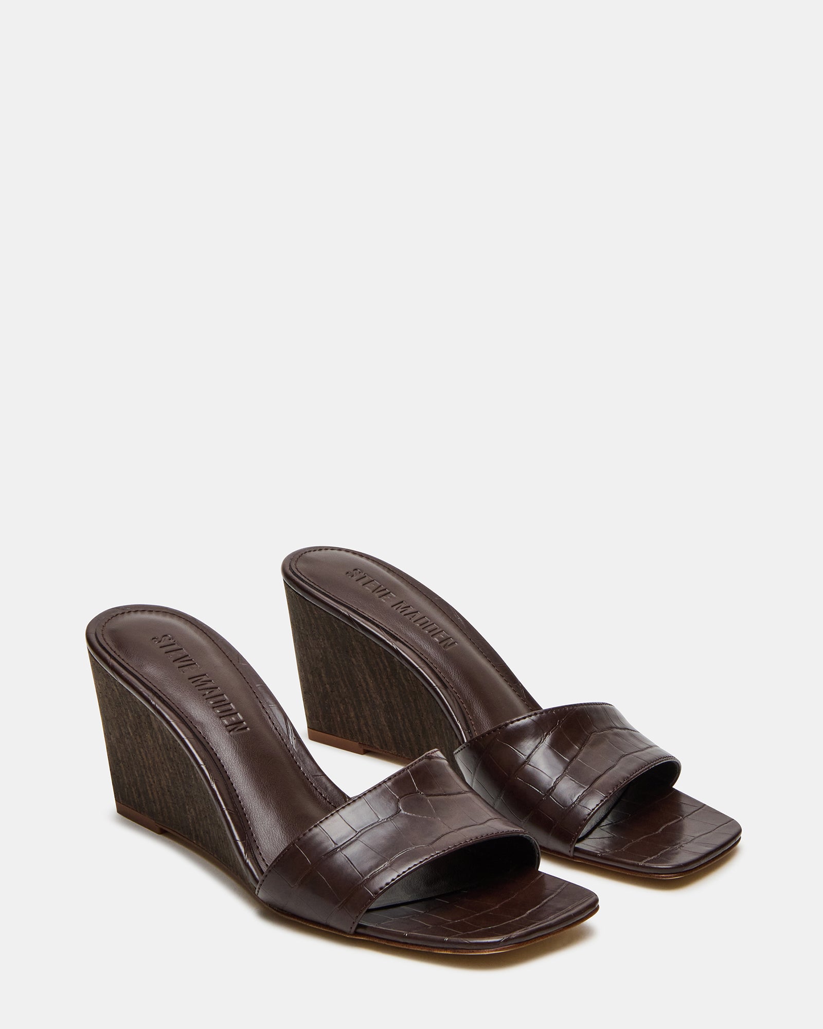 Elegant white wedge sandals paired with summer attire.