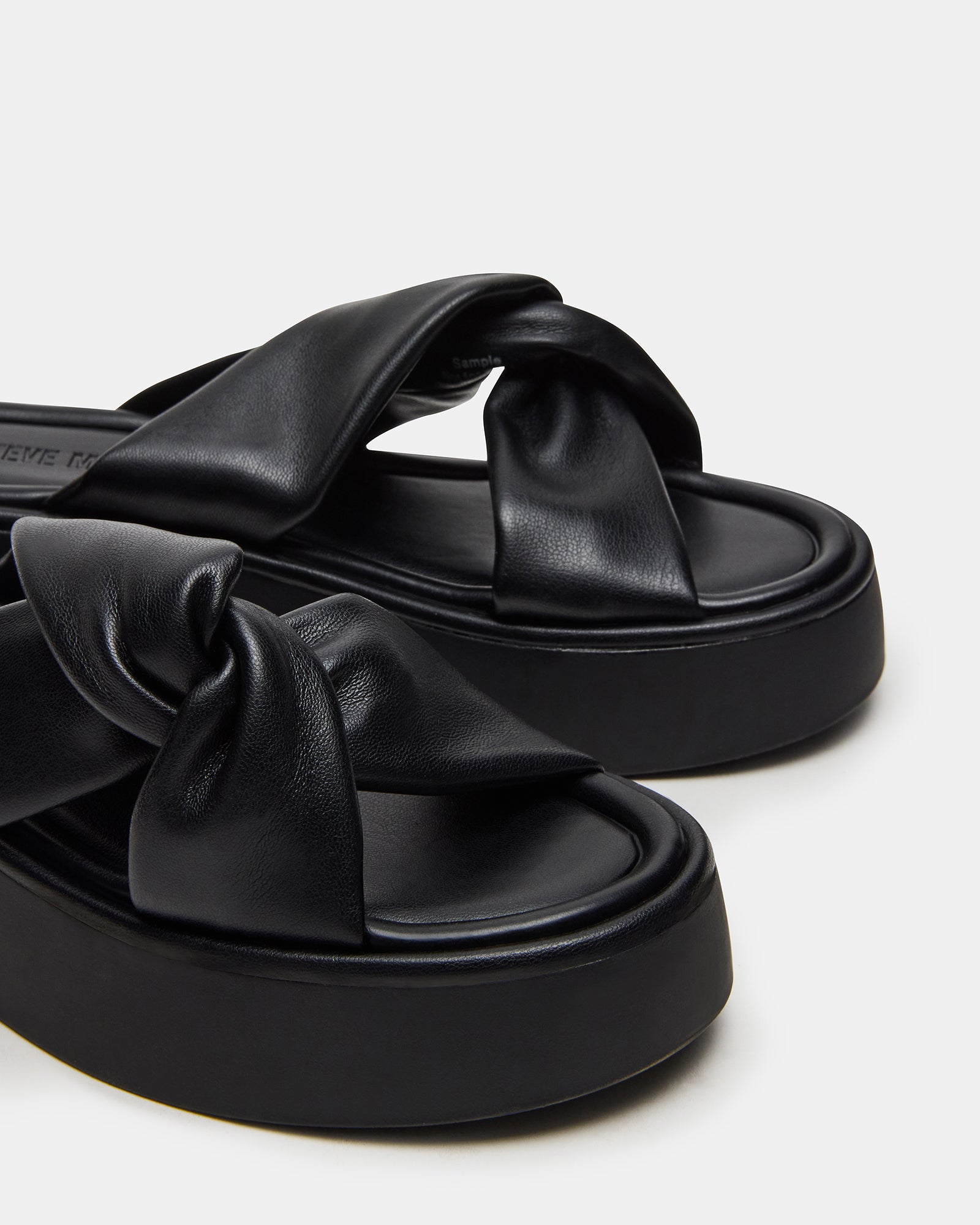 Side view of stylish black platform sandals showcasing the 1.75-inch heel.
