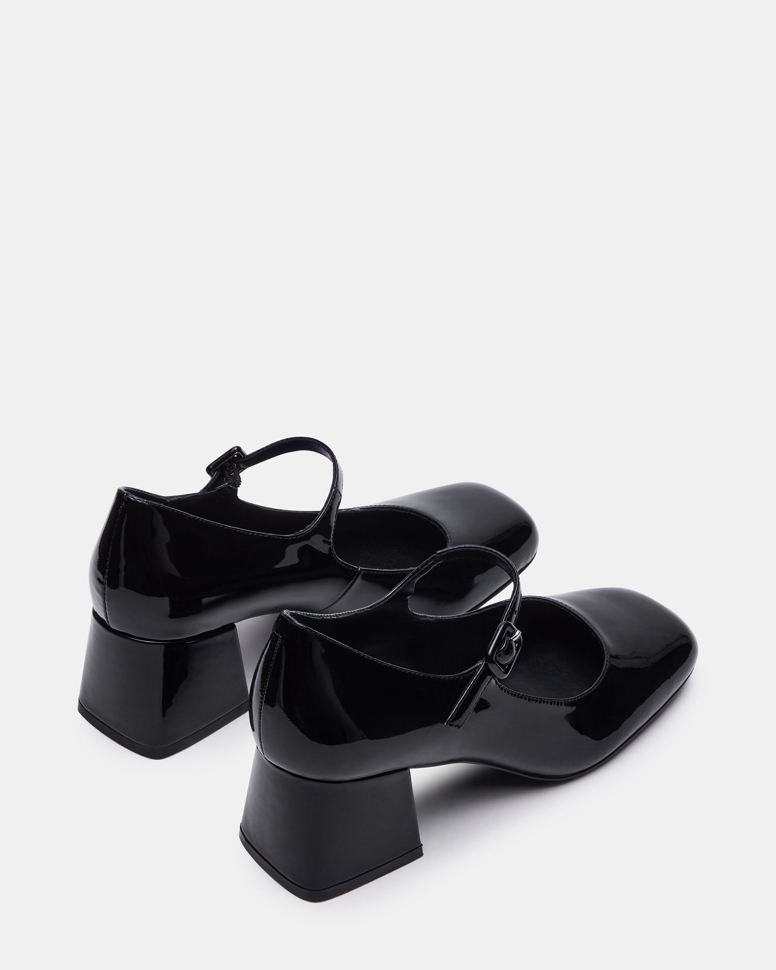 Darcey black patent loafers worn in a professional setting.