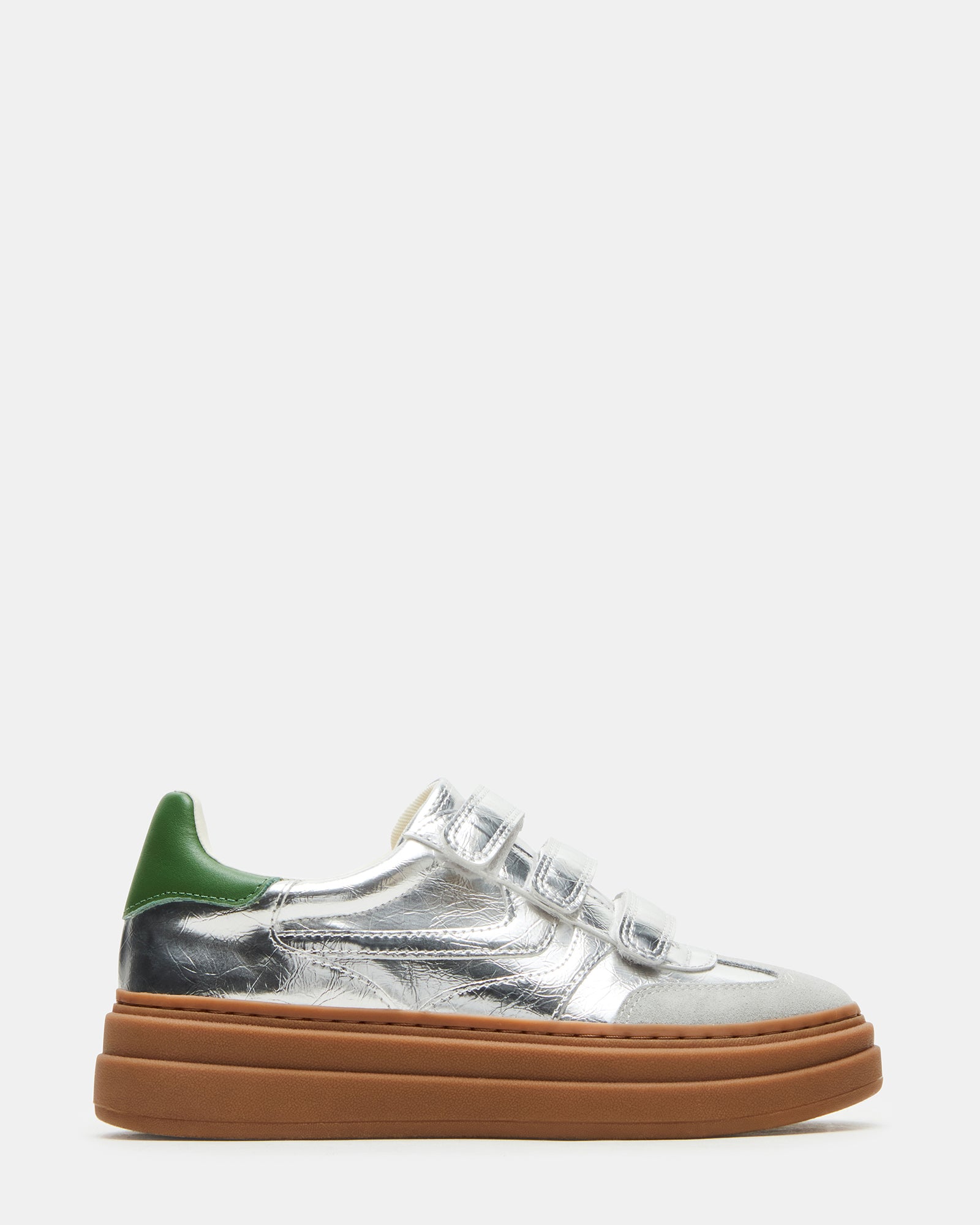 Side view of Dash Silver platform sneakers with velcro straps on a city street