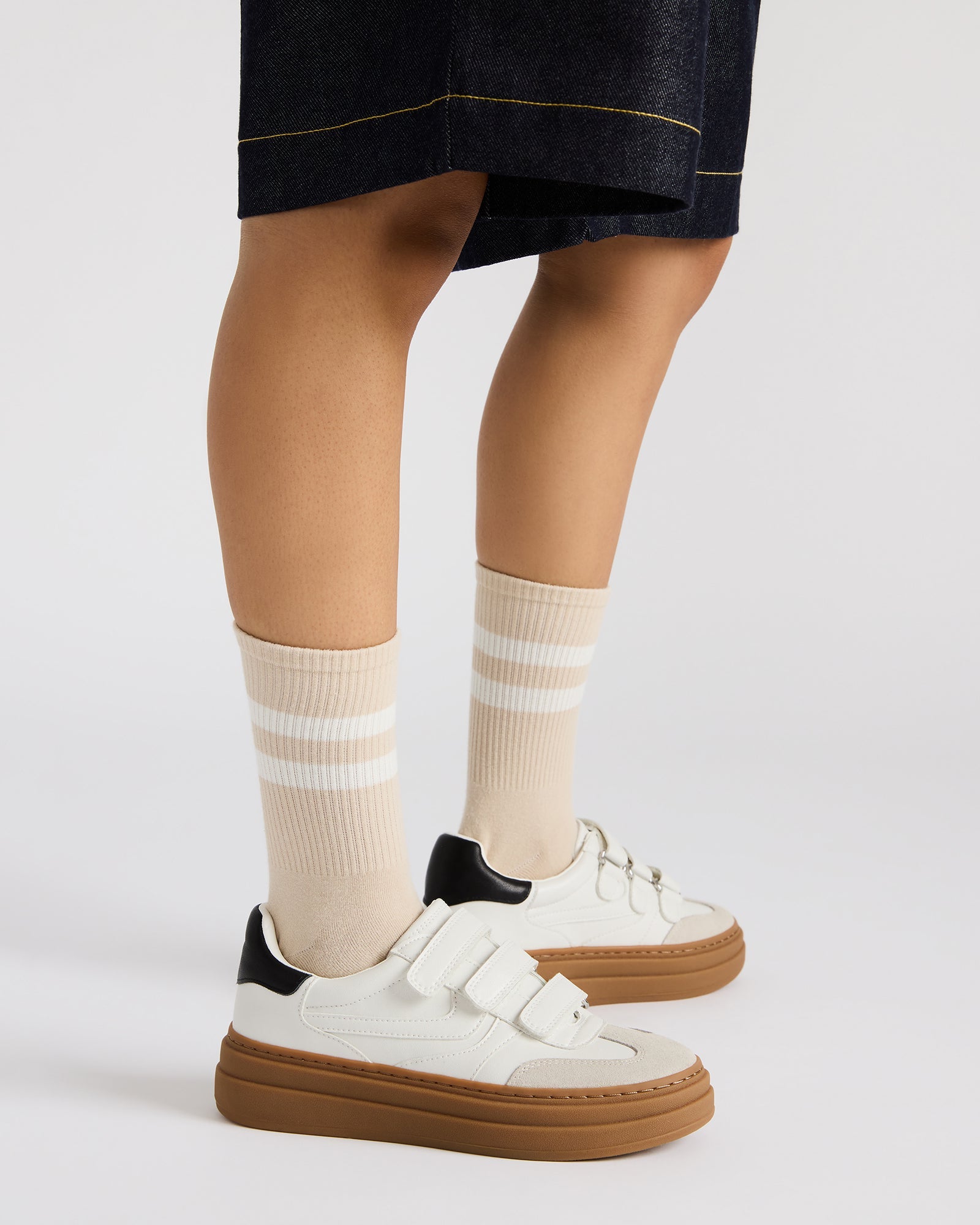 Model wearing DASH platform sneakers with Velcro straps paired with casual outfit