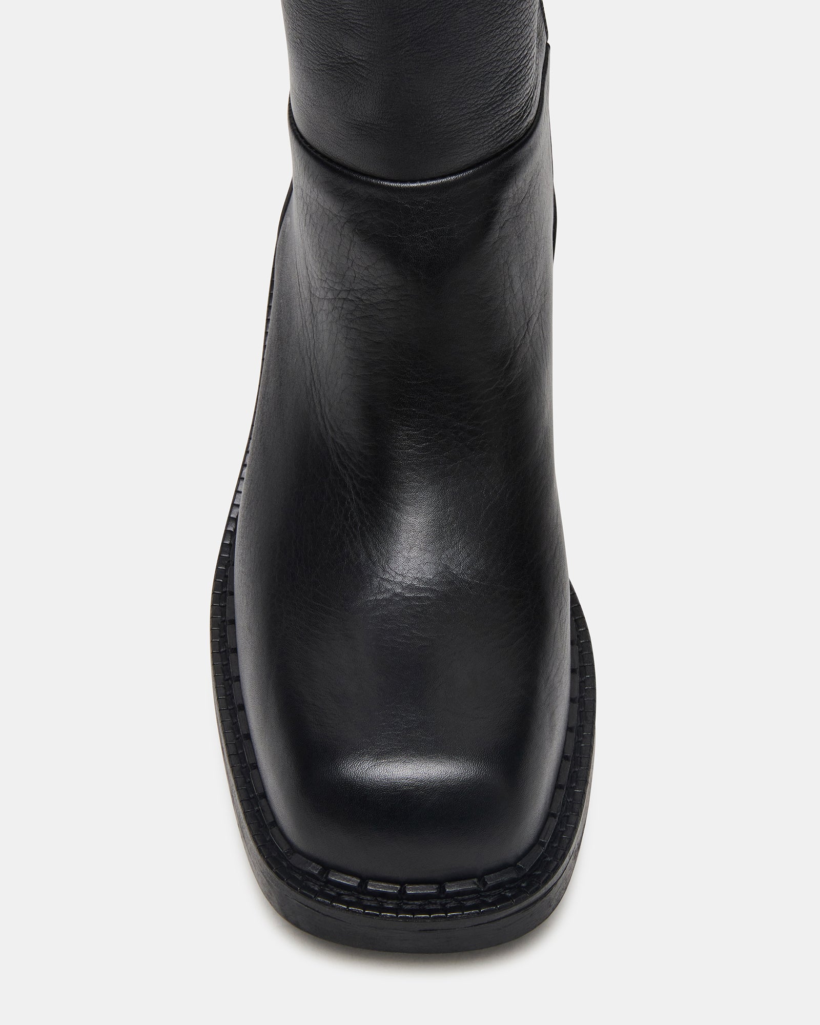 Front angle of black ankle boots with block heel for city walking.