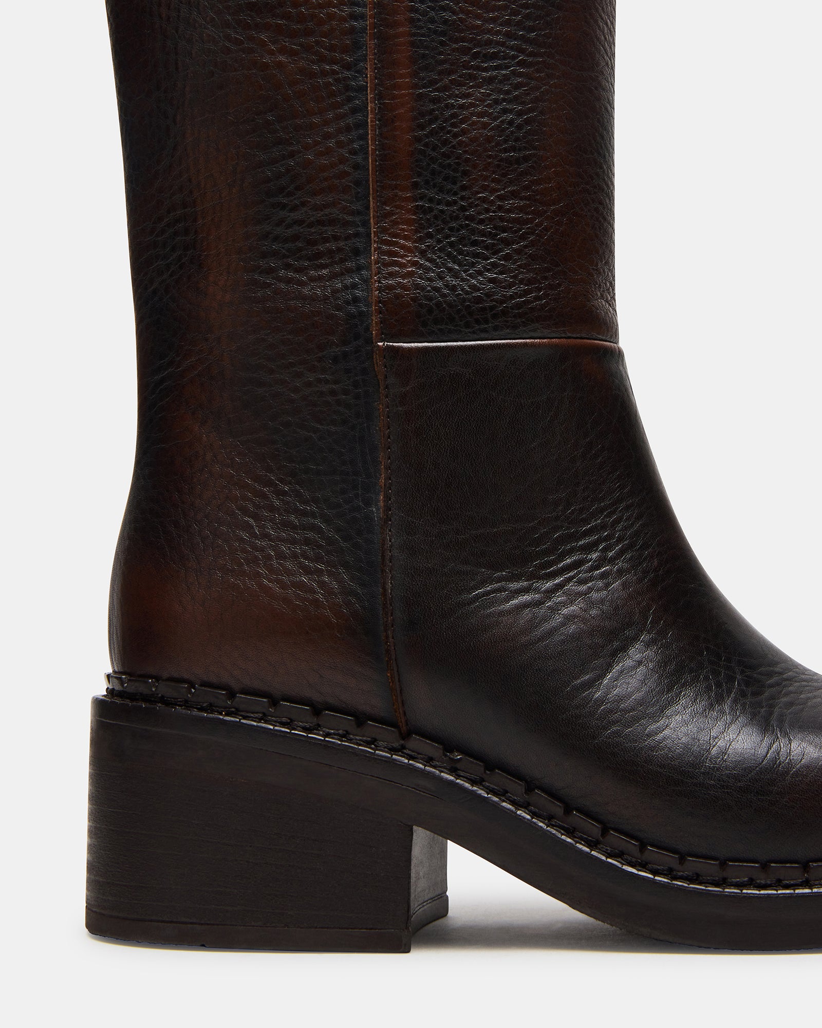 Close-up of black leather boots showing stitching and craftsmanship details