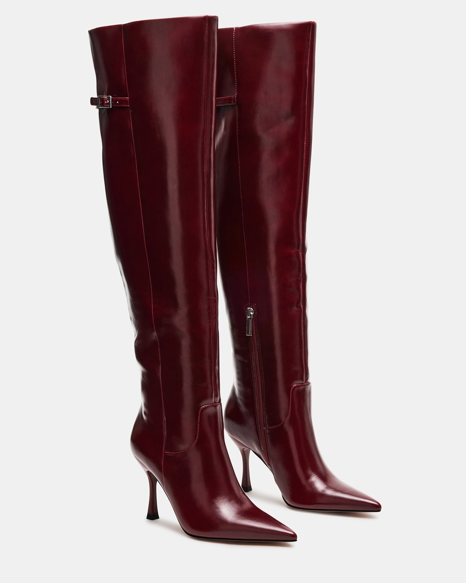 Model wearing Dawn Wine knee-high boots with a fitted dress, showcasing their sleek silhouette and versatile style