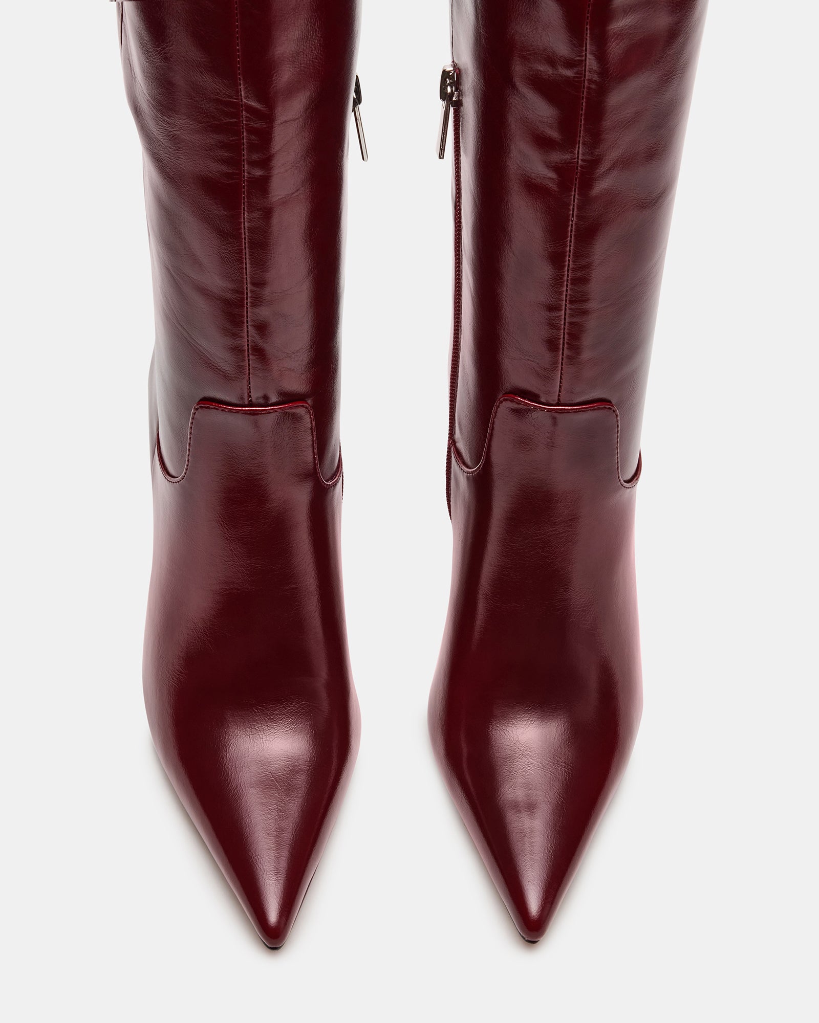 Model wearing Dawn Wine knee-high boots with a fitted dress, showcasing their sleek silhouette and versatile style