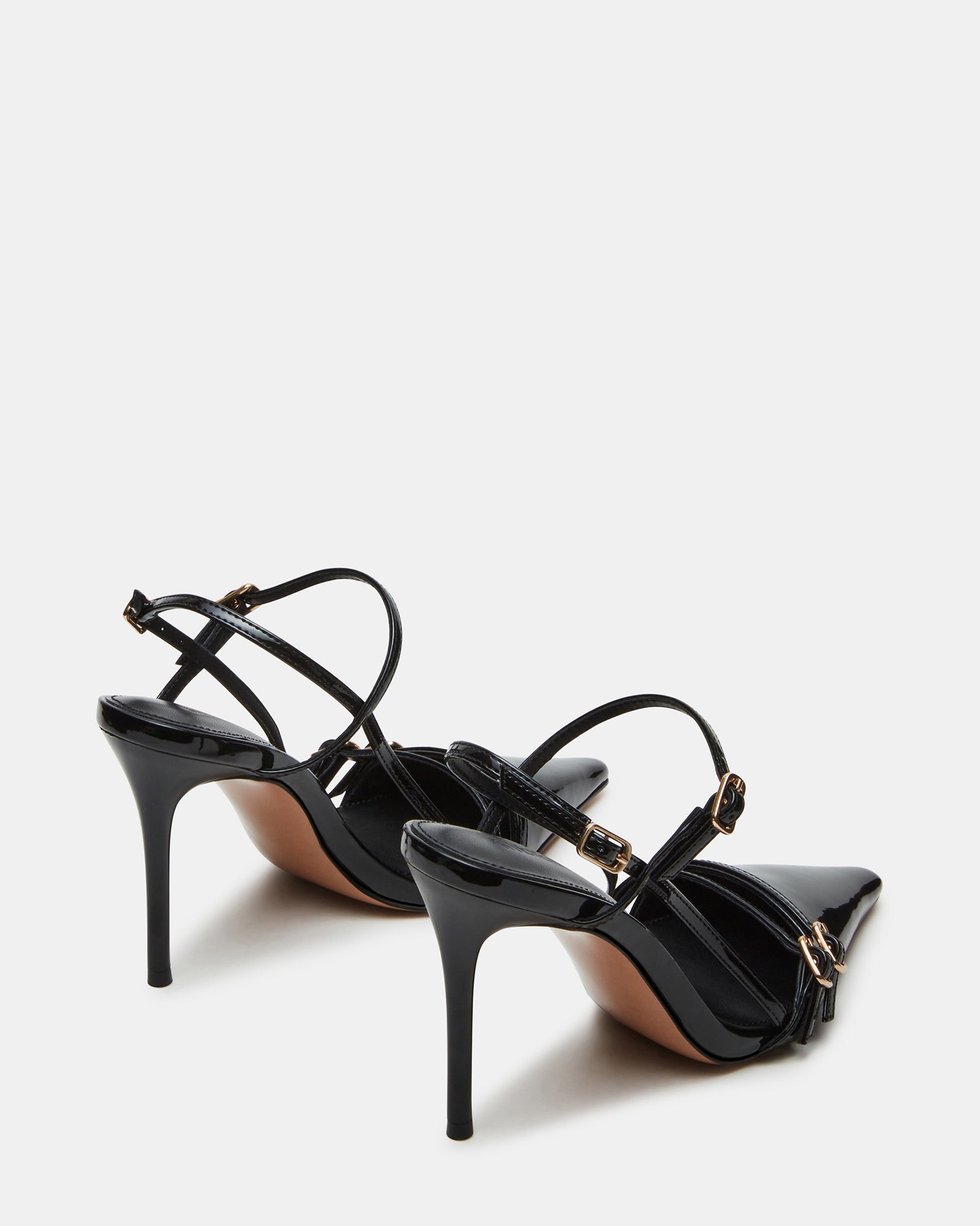 Model wearing black patent leather heels with a fitted dress for a night out