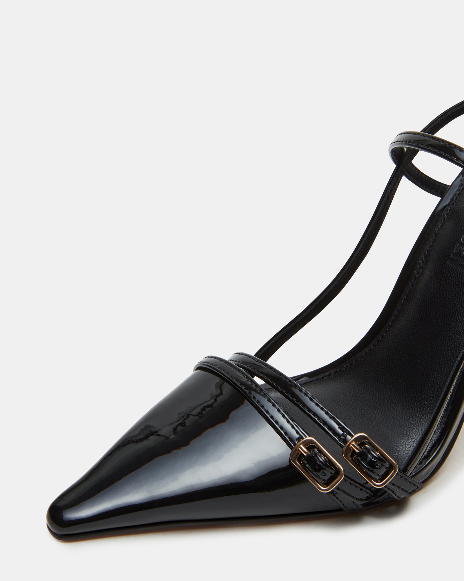 Side view of black patent leather heels with pointed toe and slingback strap