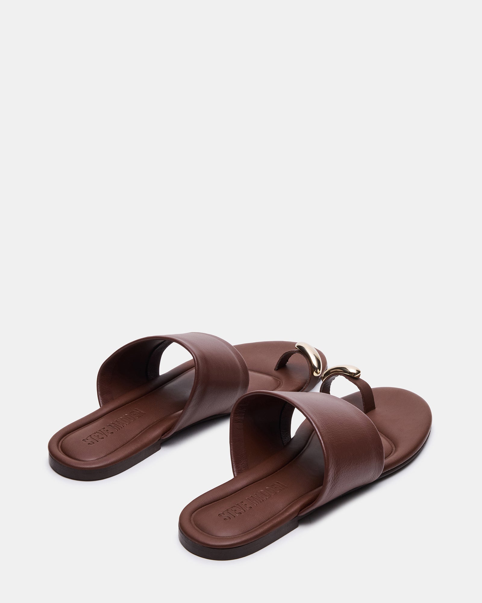 Side view of stylish leather slide sandals showing the flat sole and rounded toe