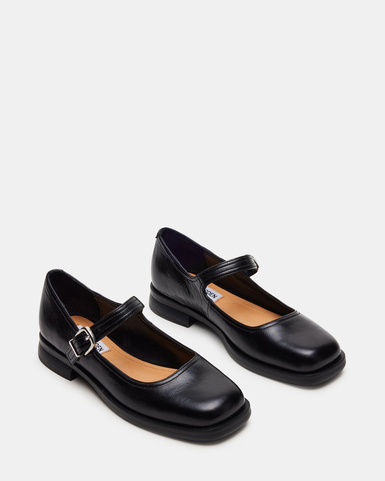Delancy black Mary Jane shoes displayed with a dress for formal occasions.