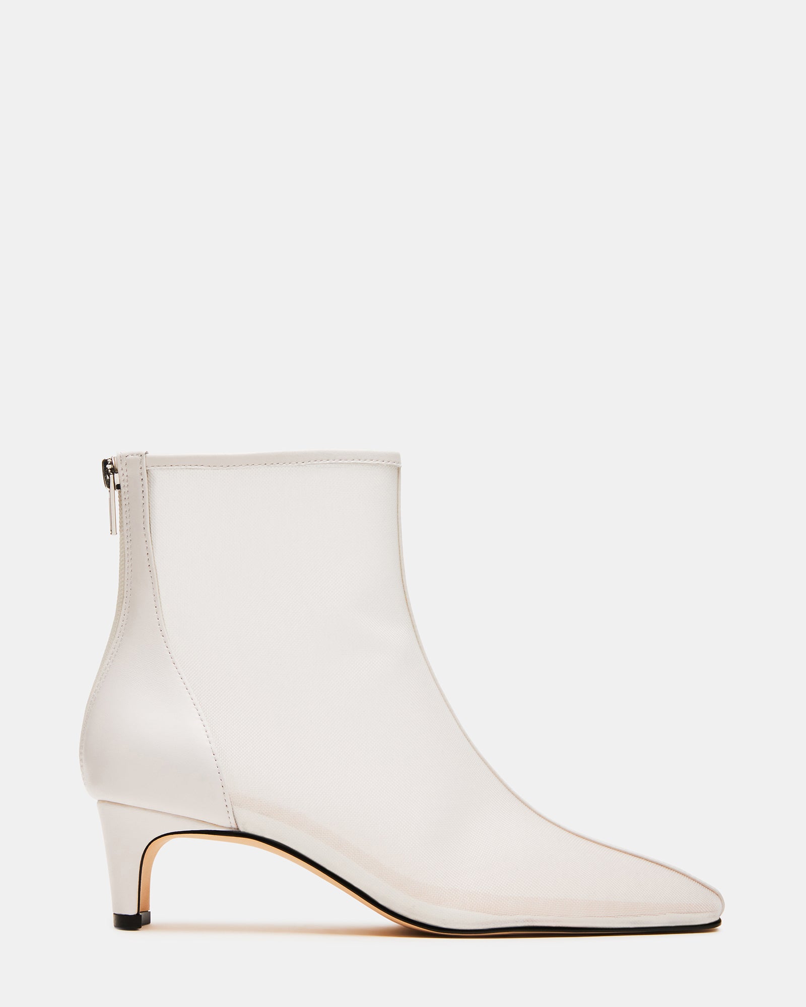 Side view of Delvie white booties showing pointed toe and kitten heel