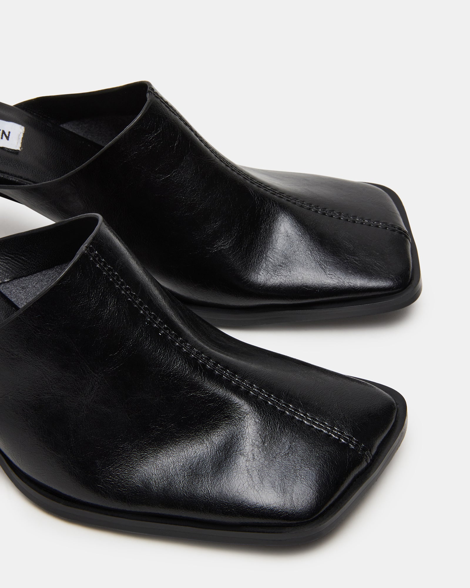 Close-up of mules leather texture and heel construction