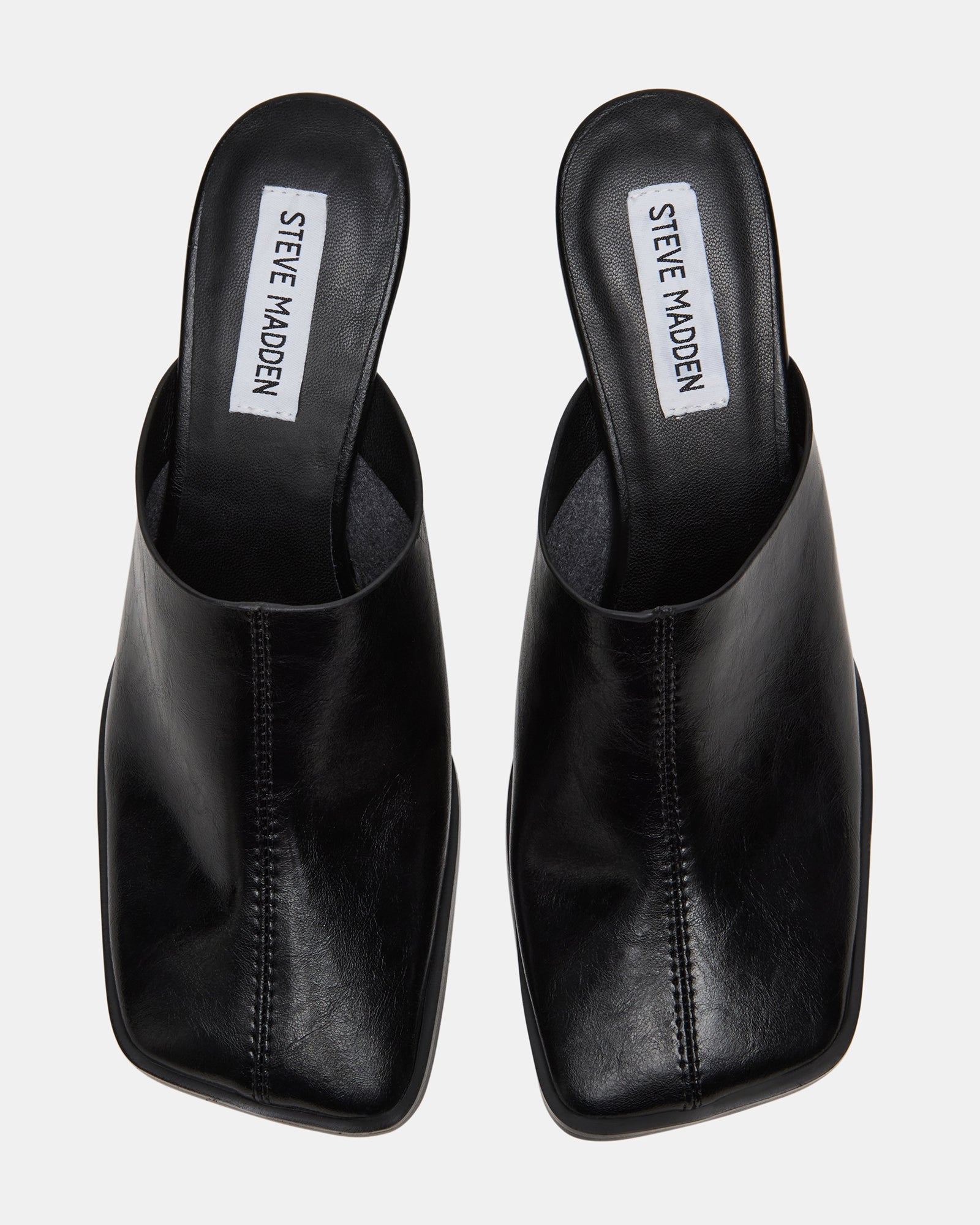 Side view of black leather mules showing square toe design
