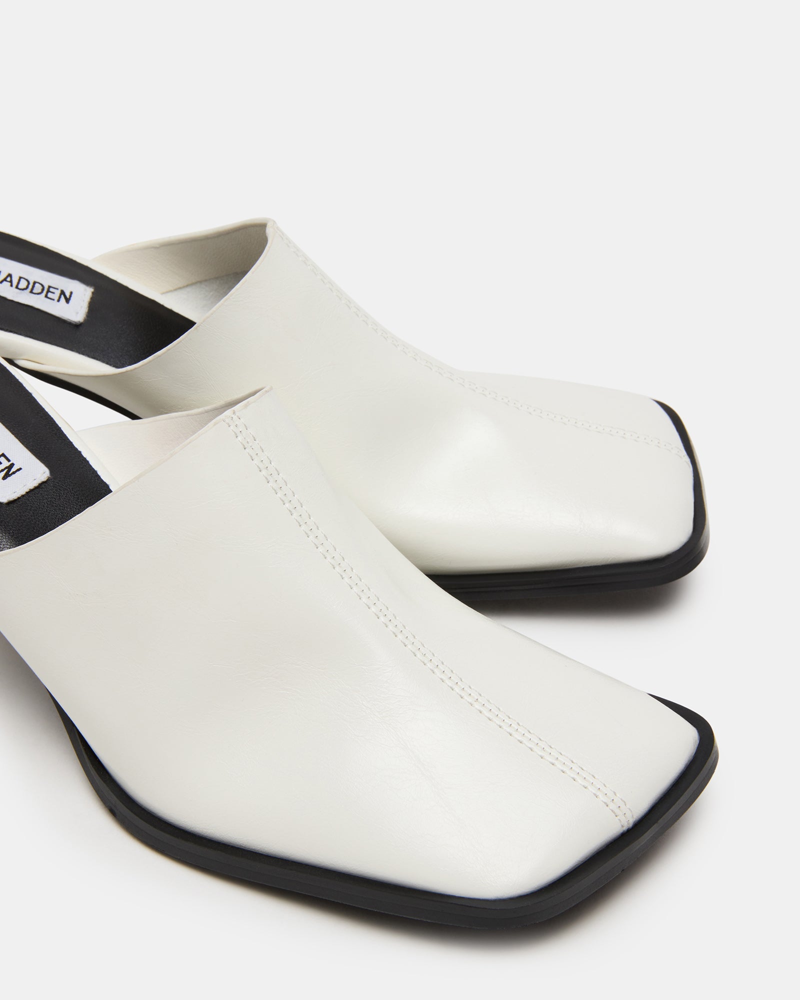 Top angle shot of womens leather mules styled with cropped denim for everyday look
