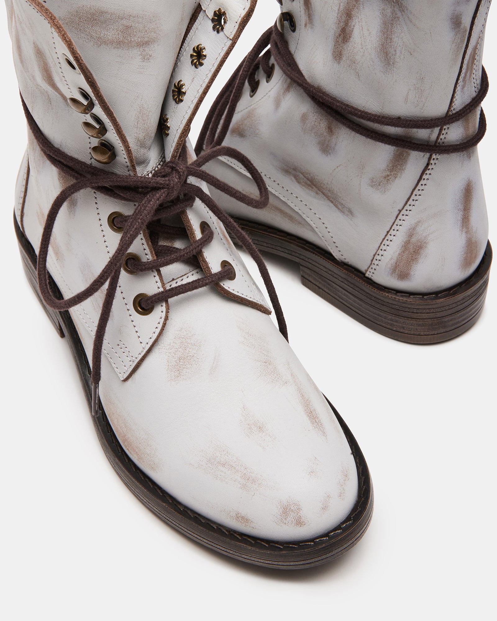 Side view of DEVIE brown leather booties showcasing the laced closure.