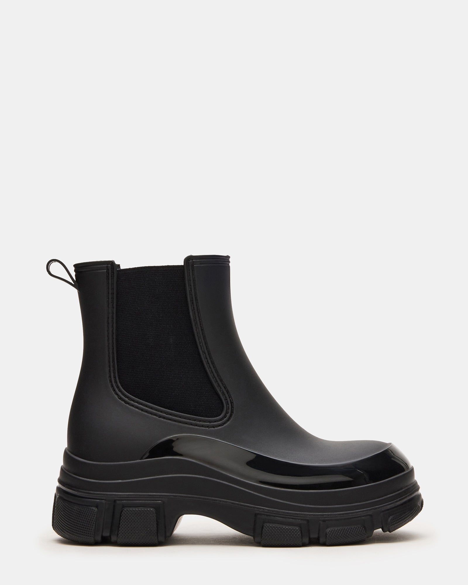 Dewdrop Black Chelsea boots in a stylish outdoor setting