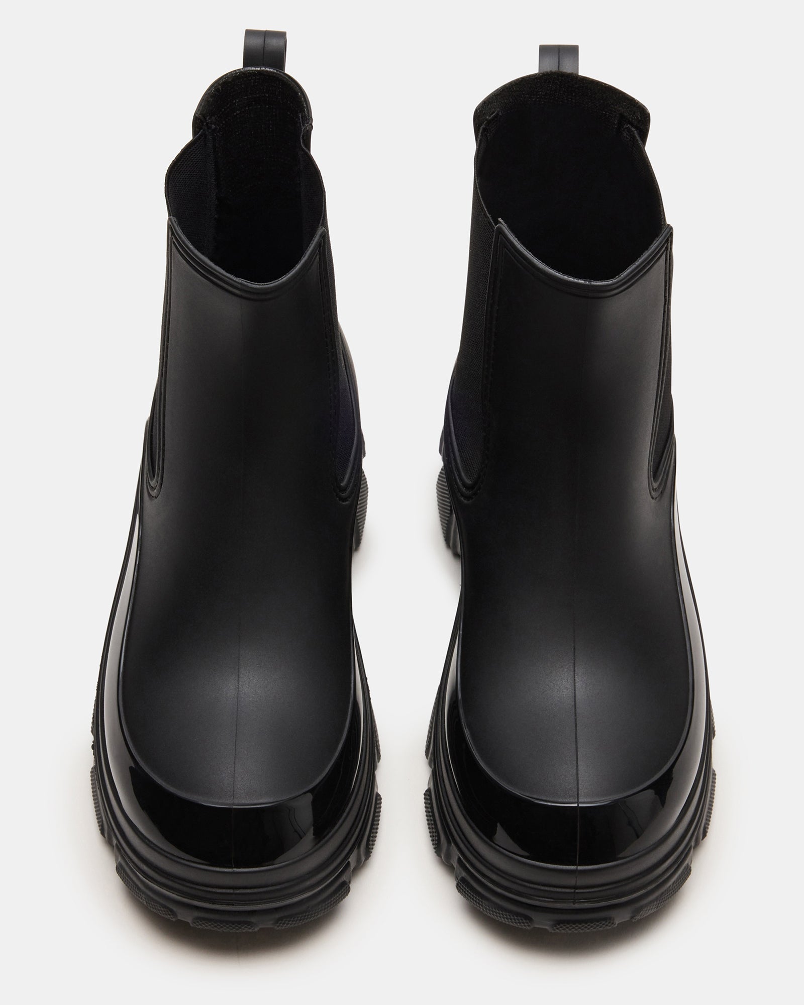 Dewdrop Black Chelsea boots in a stylish outdoor setting