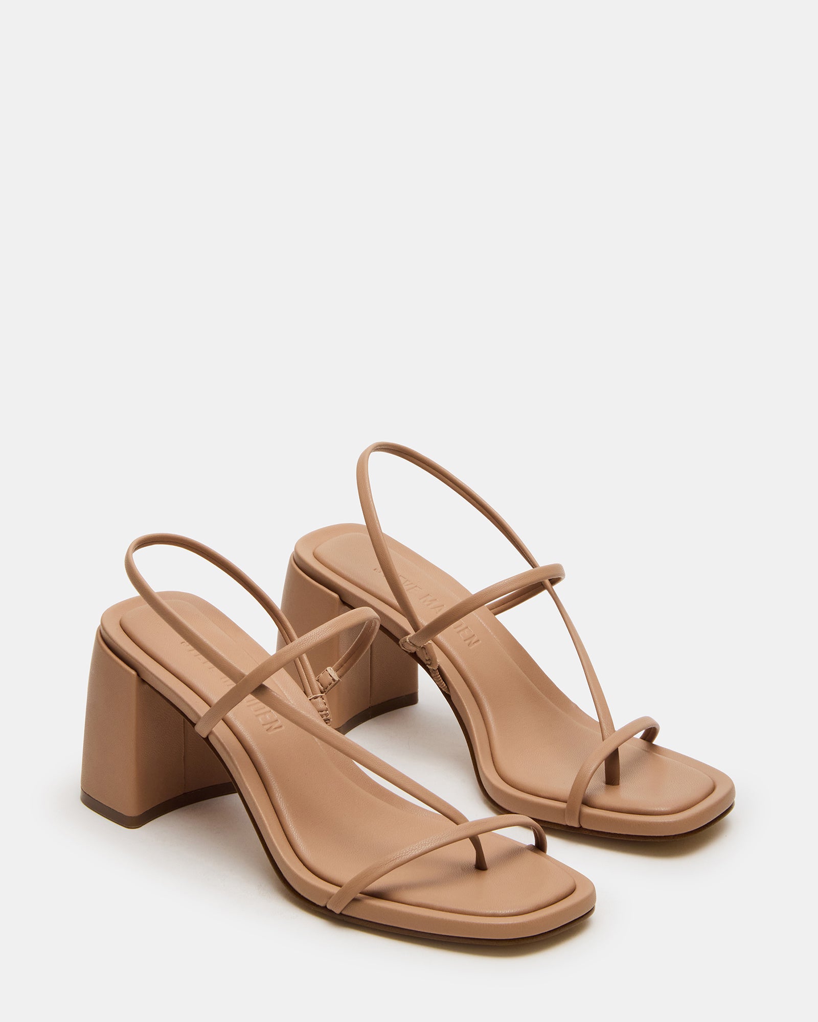 Nude strappy heels paired with cropped trousers for daytime outfit