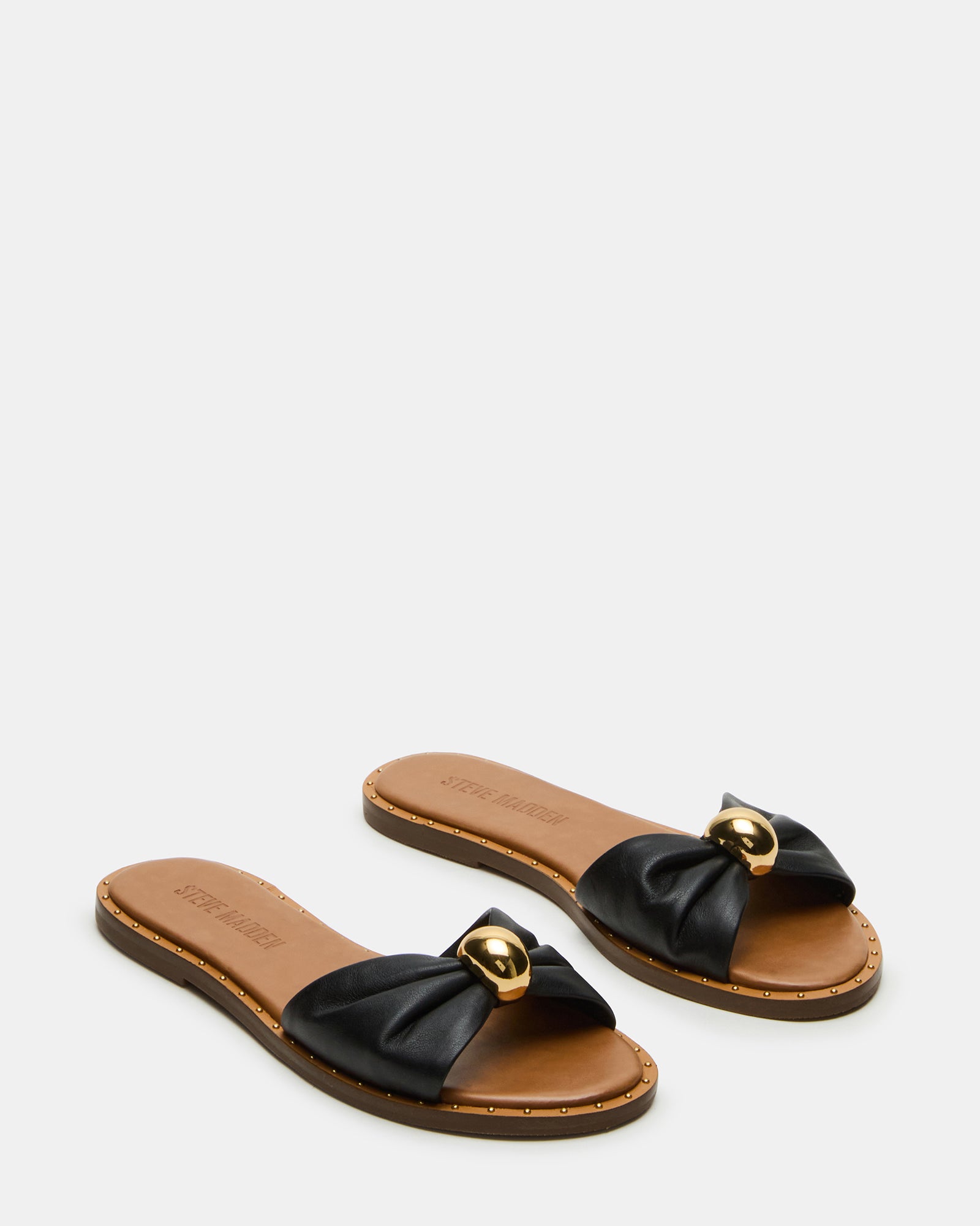 Stylish leather slides paired with casual denim for a laid-back look.