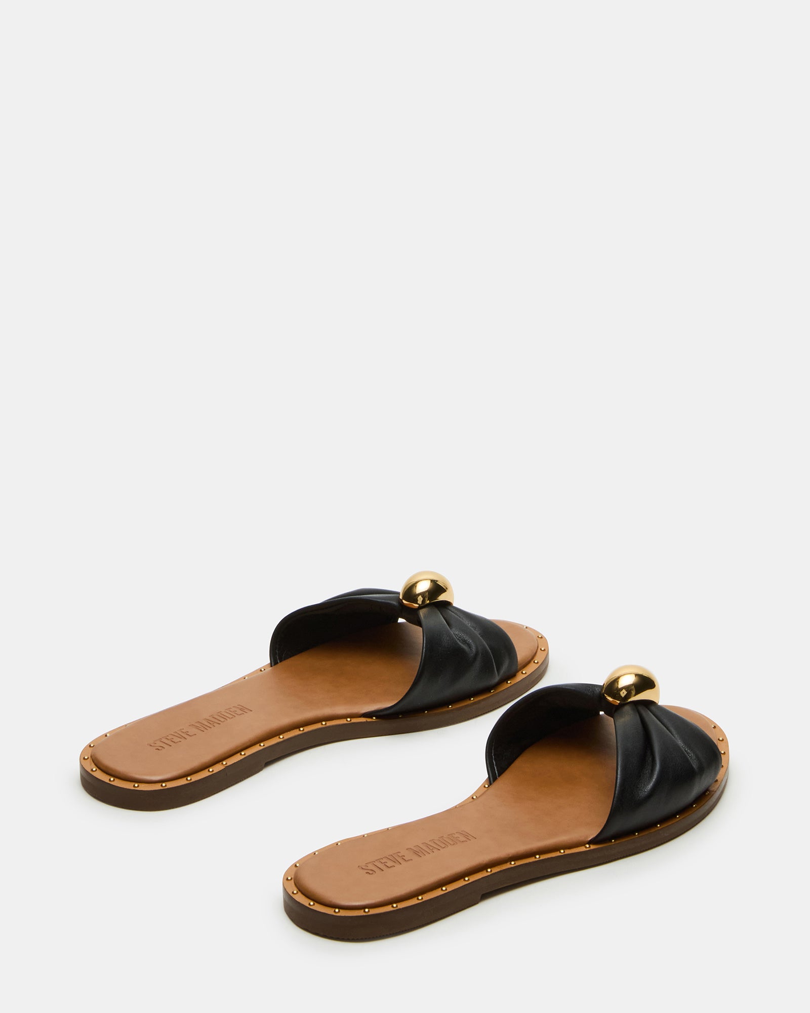 Stylish leather slides paired with casual denim for a laid-back look.