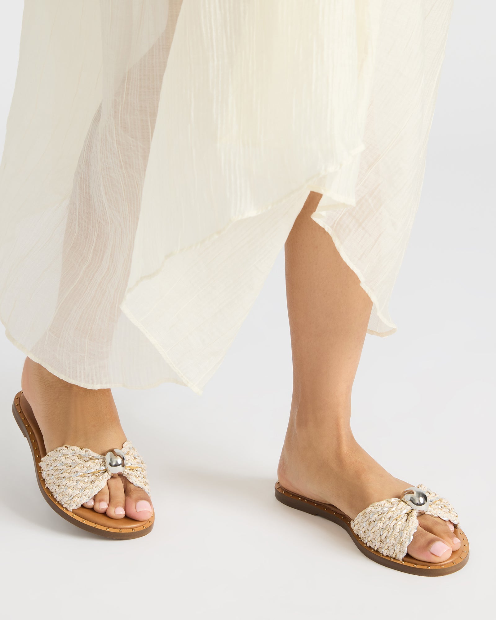 Side view of womens platform sandals highlighting raffia texture and heel height