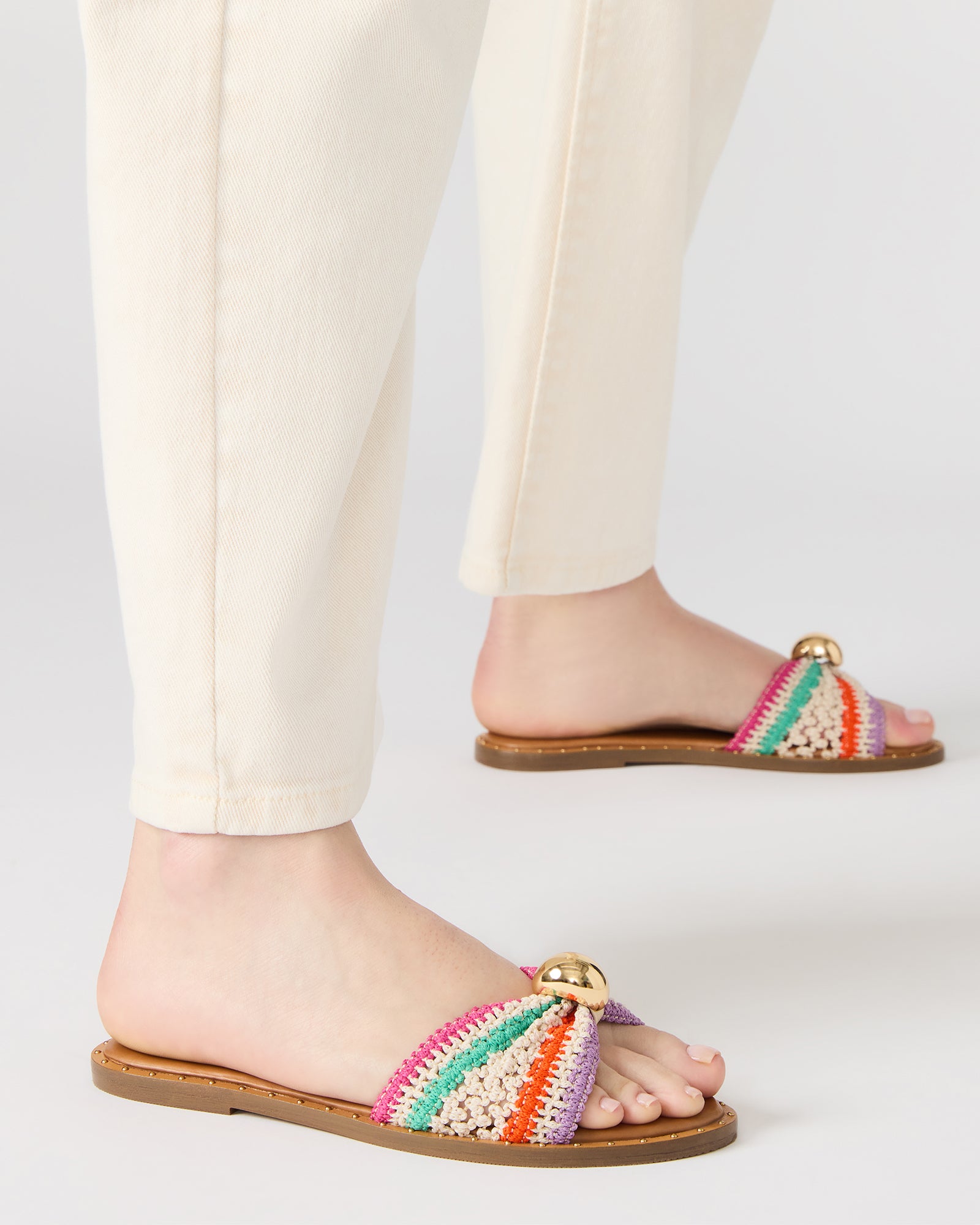 Close-up of mini stud details on raffia sandals