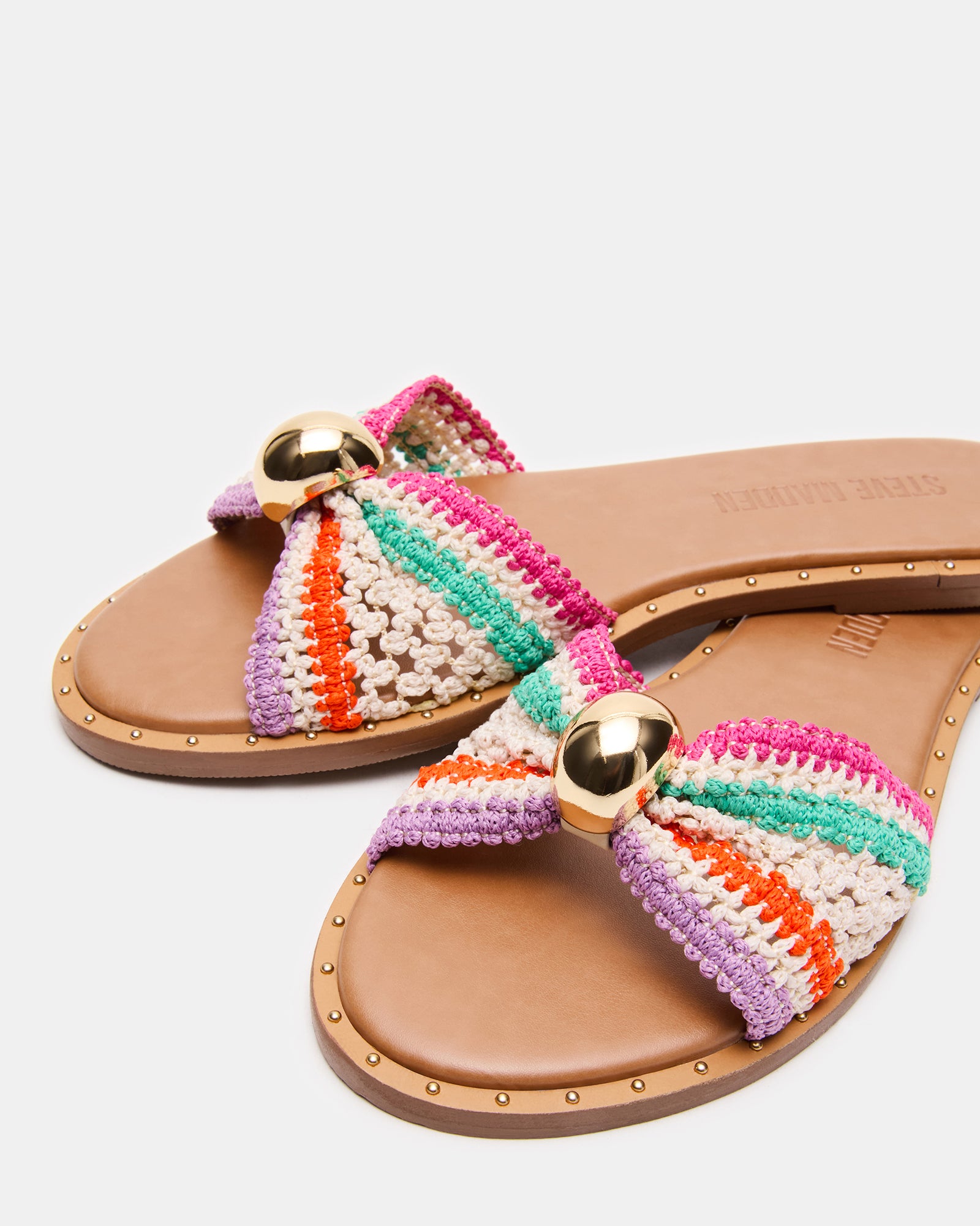 Dipsy Multi raffia slide sandals modeled on feet outdoors