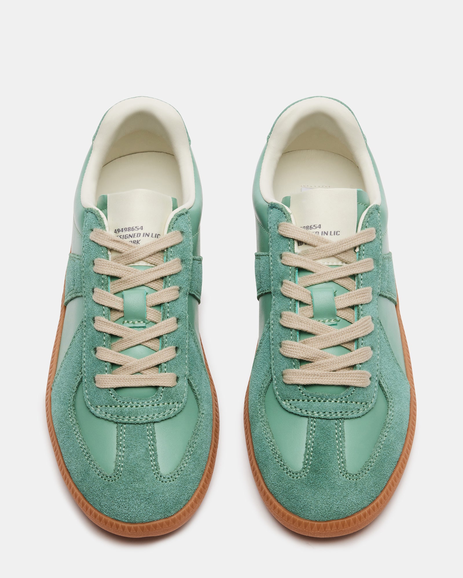 Close-up of DIXIN green leather sneakers showing contrasting panel detail