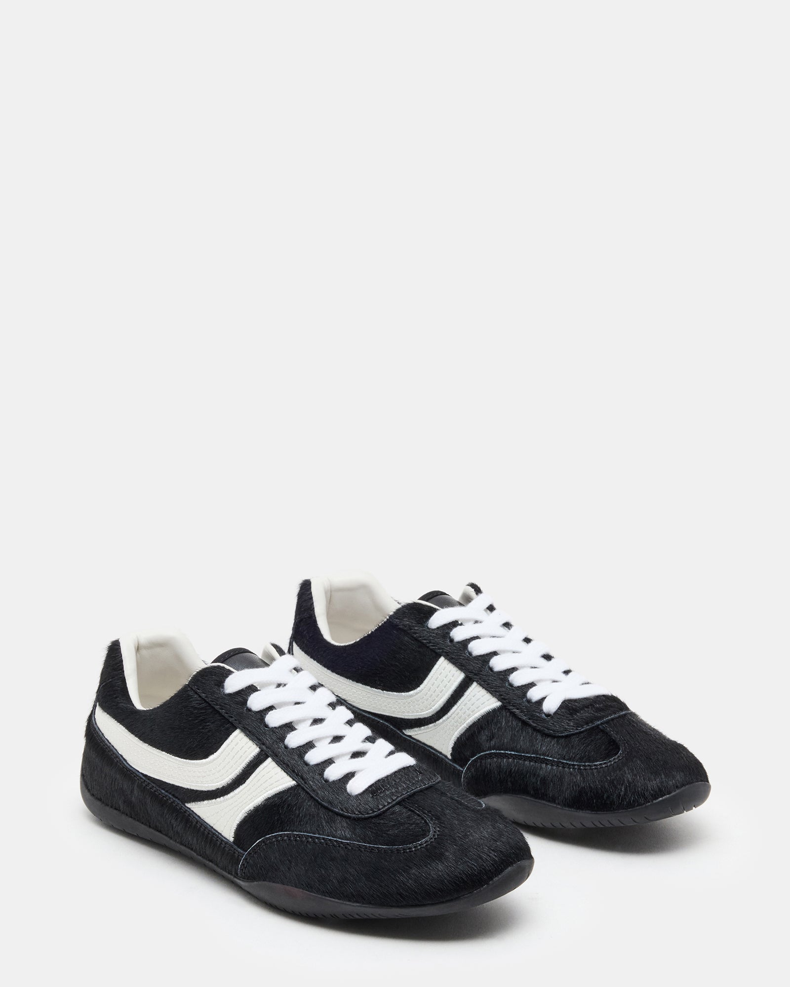 Top-down view of black multi low top sneakers styled with weekend denim