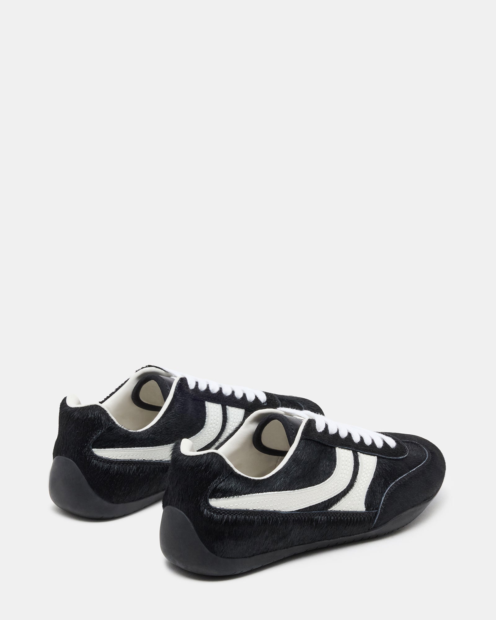 Top-down view of black multi low top sneakers styled with weekend denim