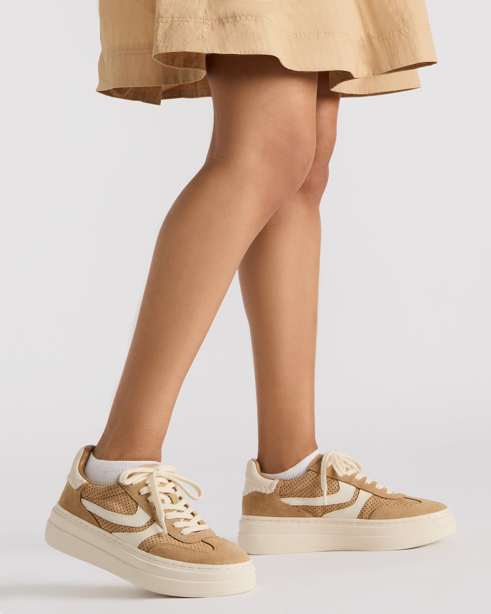 Close-up of the lace-up closure and perforated detailing on Dodge sneakers