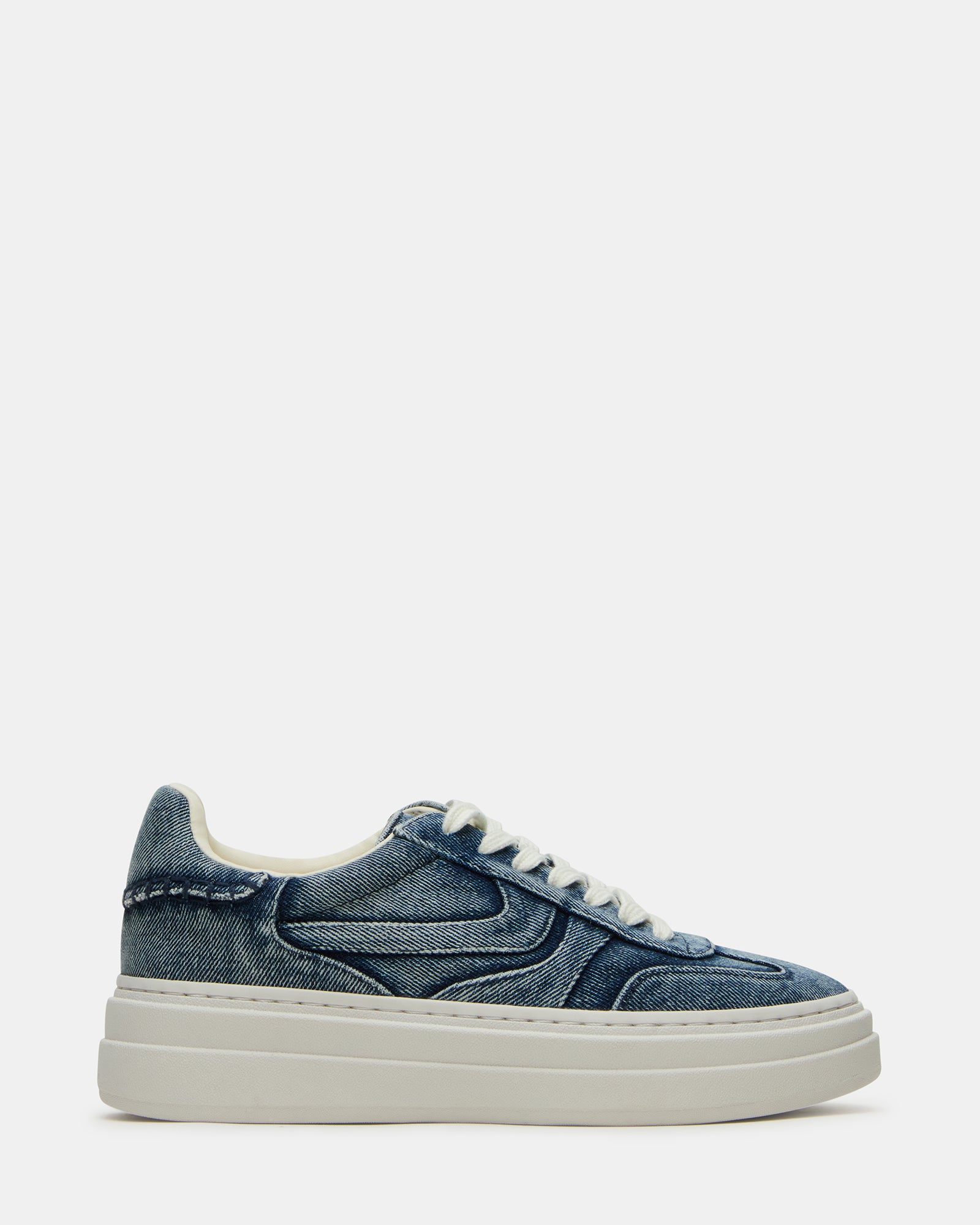 Dodge white sneakers paired with jeans for a casual look