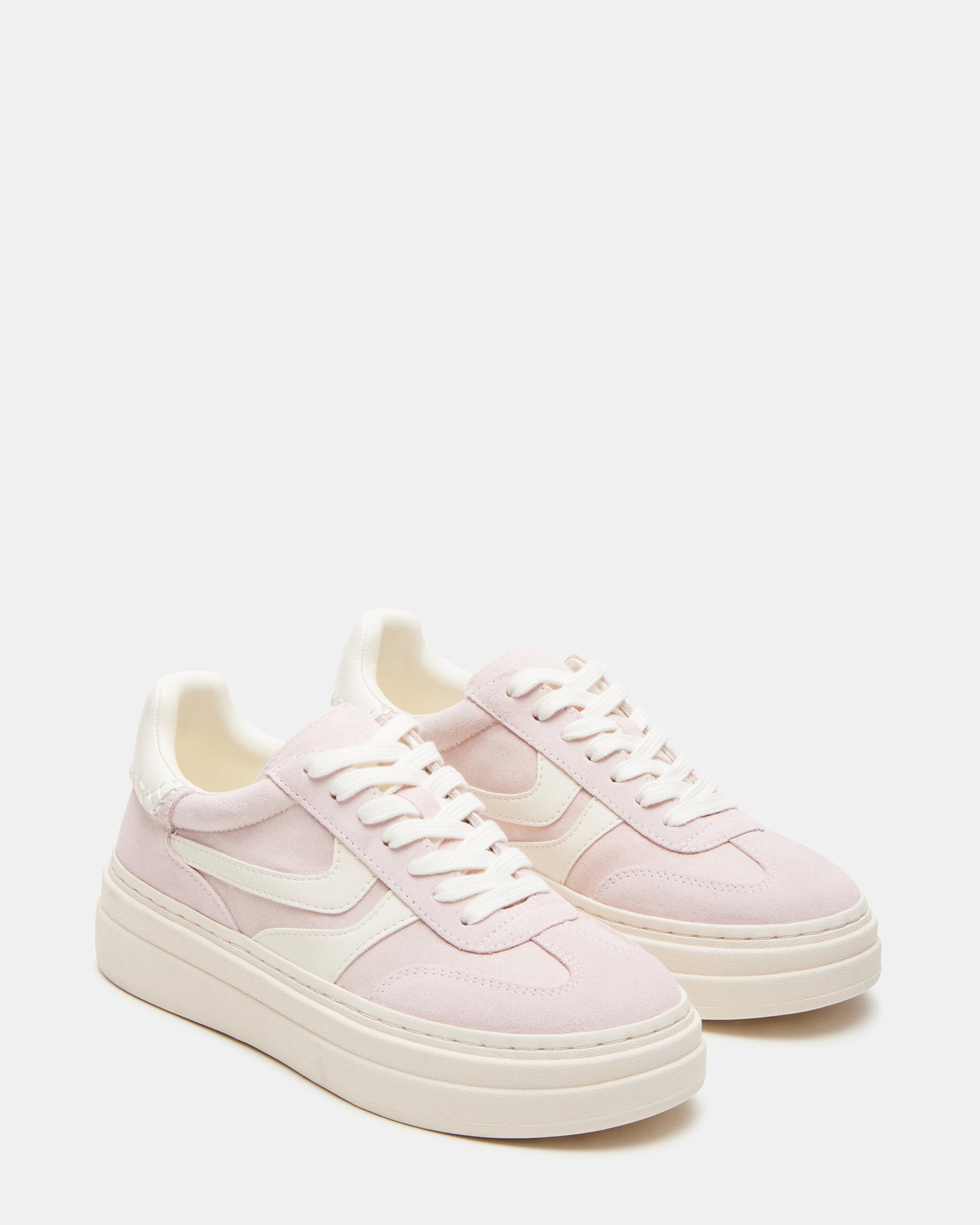 Lifestyle shot of white sneakers styled for NYC weekend outfit