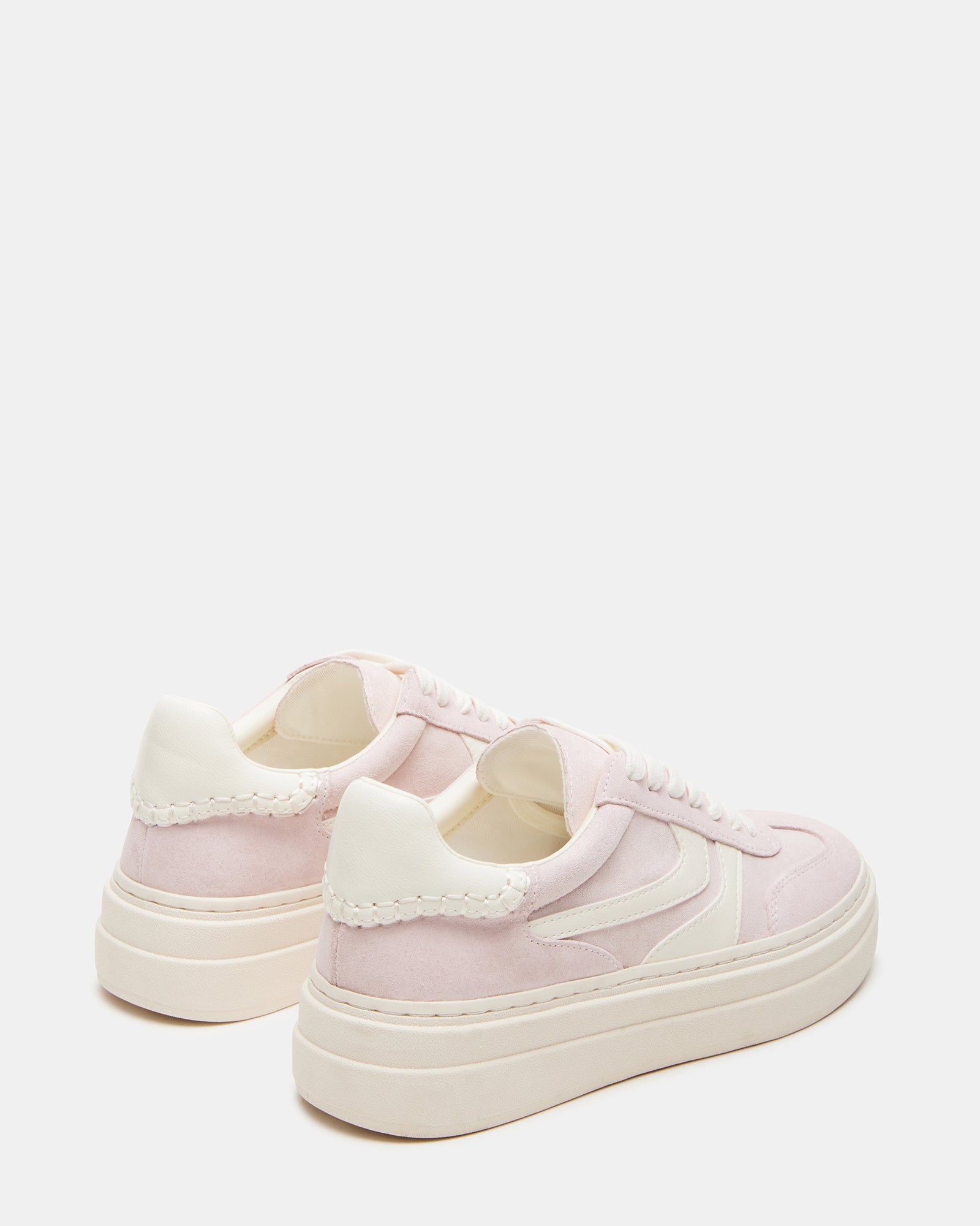 Lifestyle shot of white sneakers styled for NYC weekend outfit