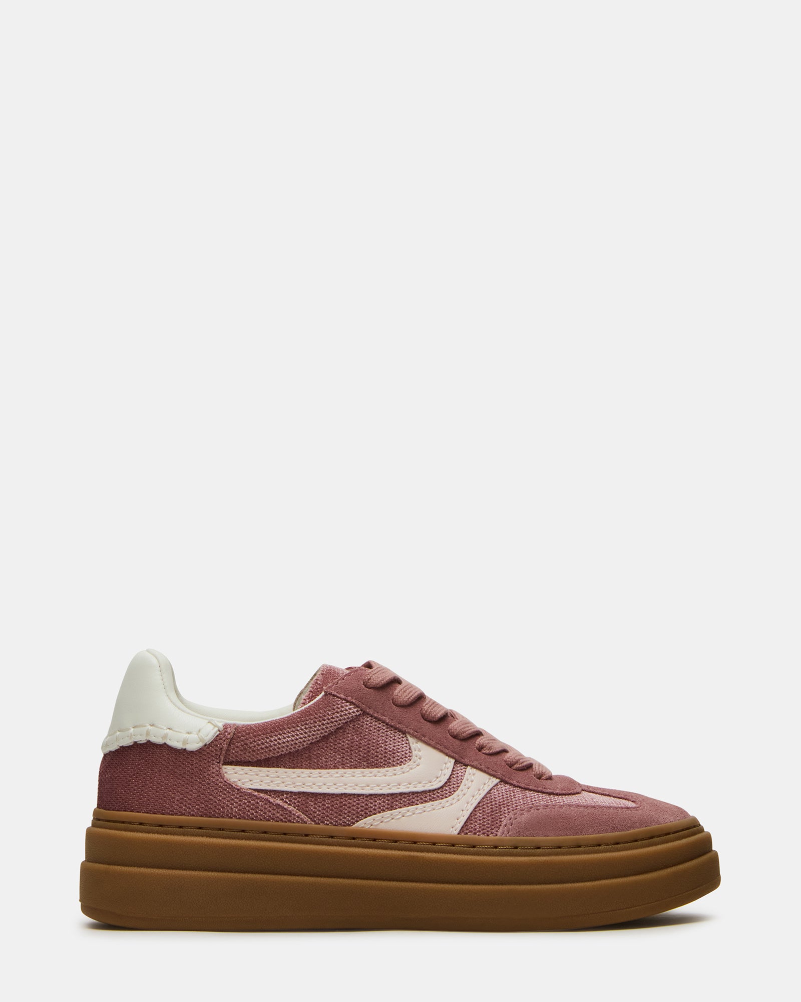 Side view of MauveStride low-top sneakers worn with chinos in urban Atlanta setting