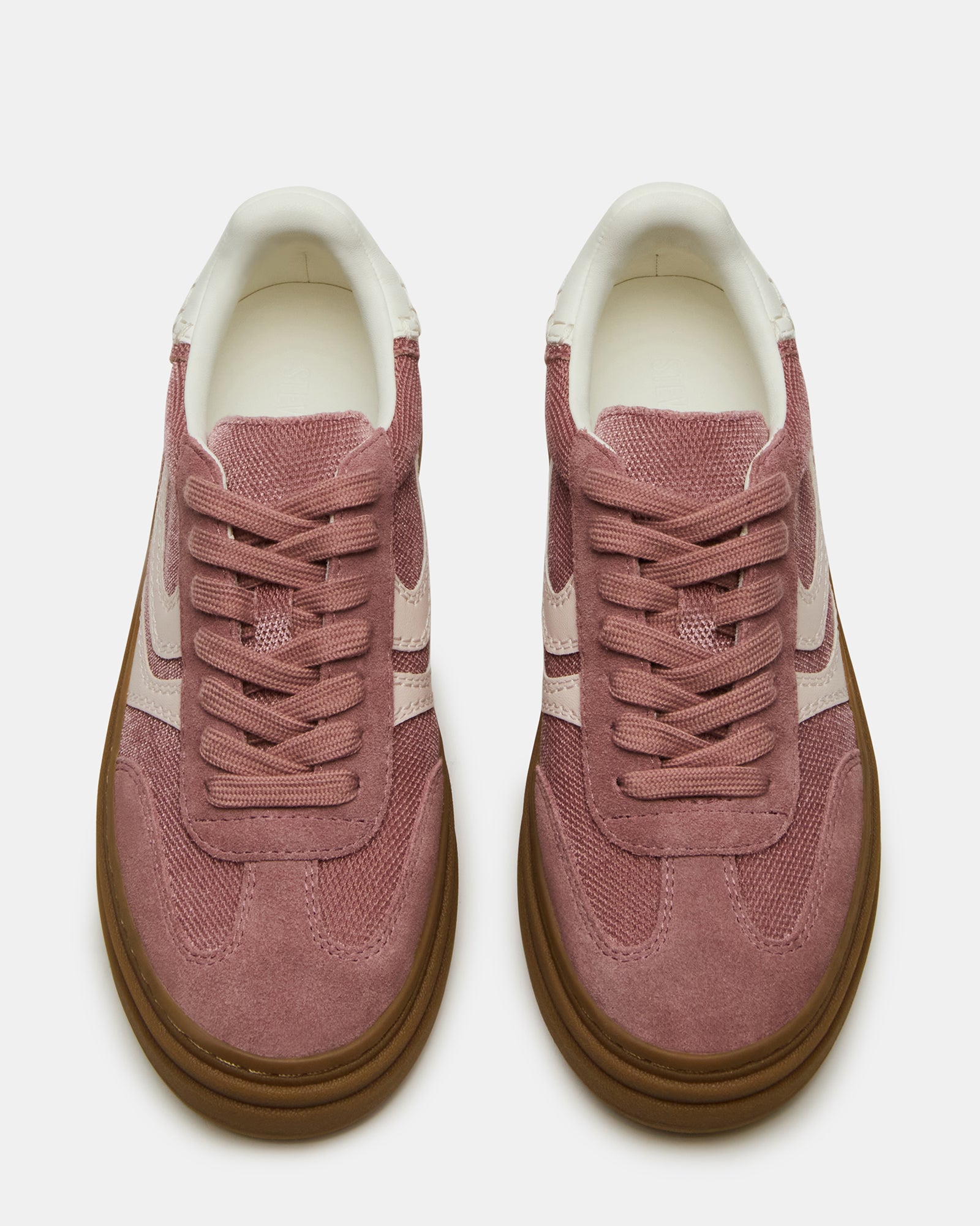Side view of MauveStride low-top sneakers worn with chinos in urban Atlanta setting