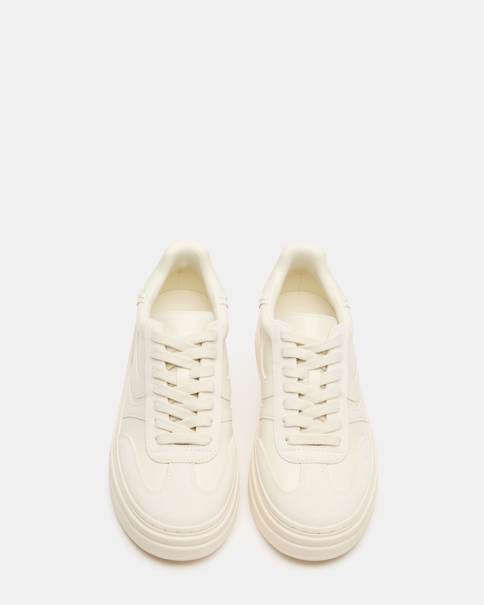 Bottega Off-White sneakers displayed from the side in a casual setting.