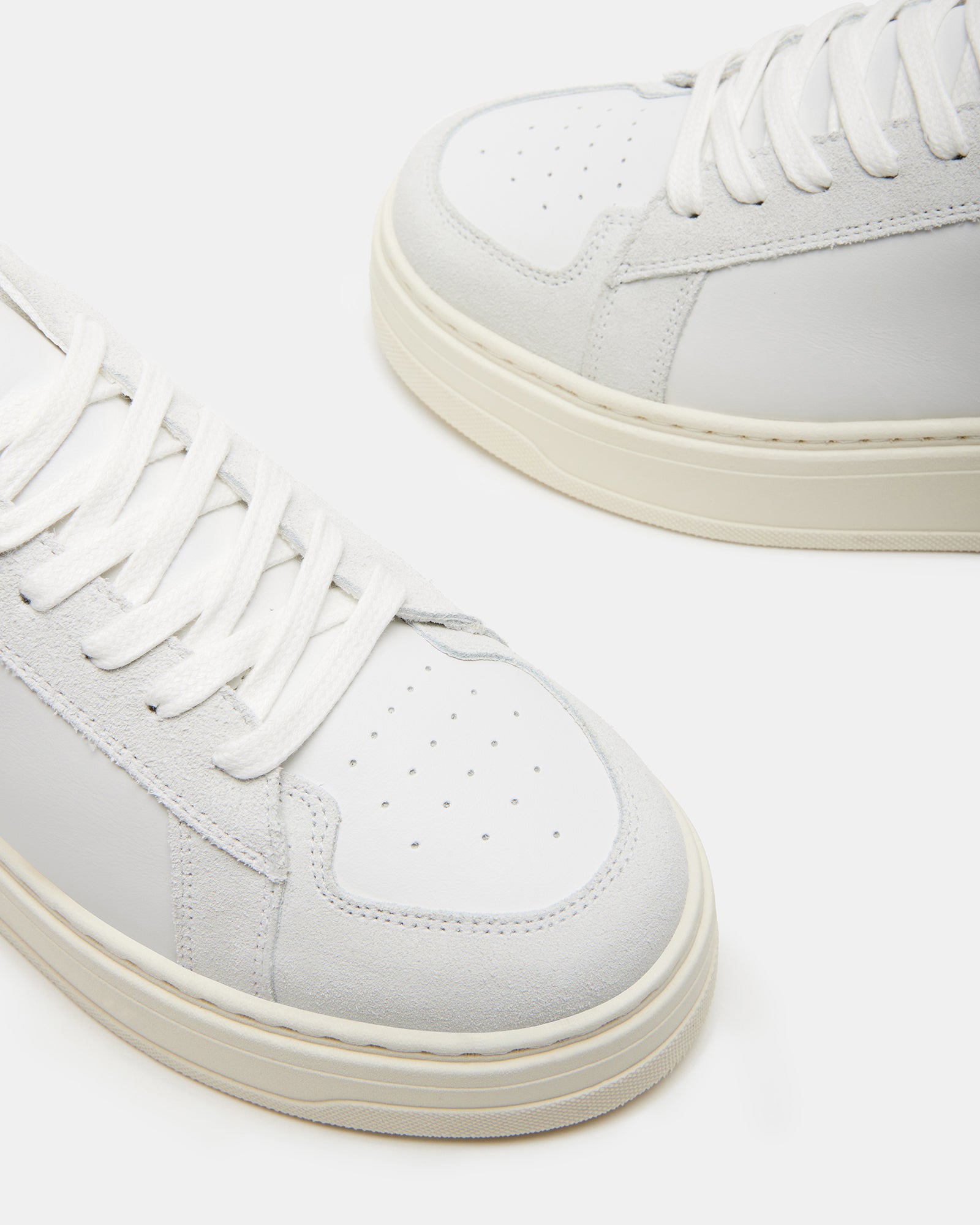 Close-up detail of the synthetic sole and textile lining of the white sneaker