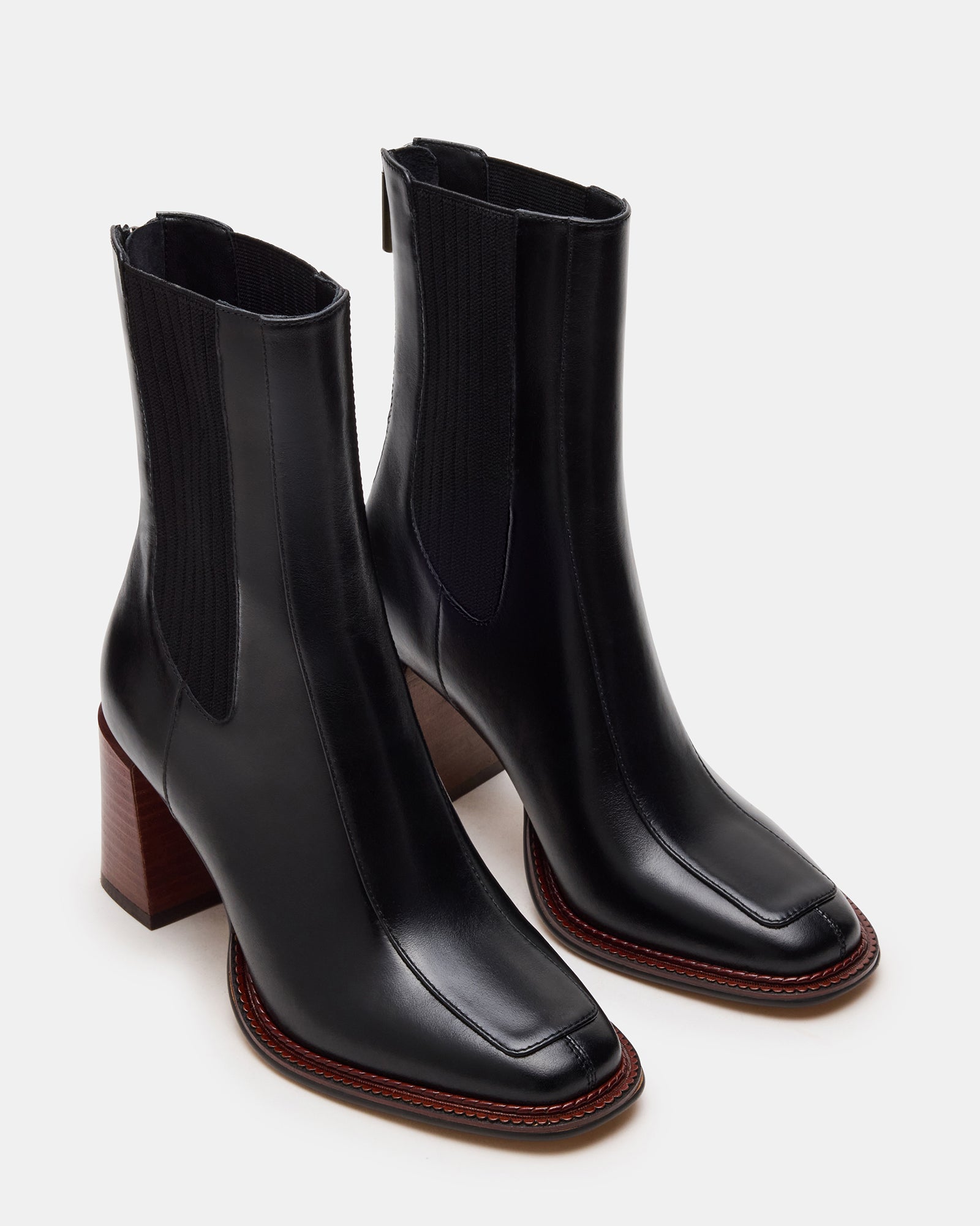 Close-up of black leather ankle boots displaying the durable material and stylish design