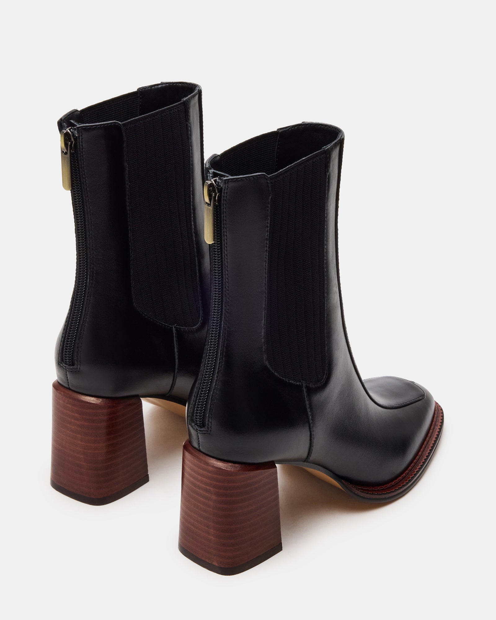 Close-up of black leather ankle boots displaying the durable material and stylish design