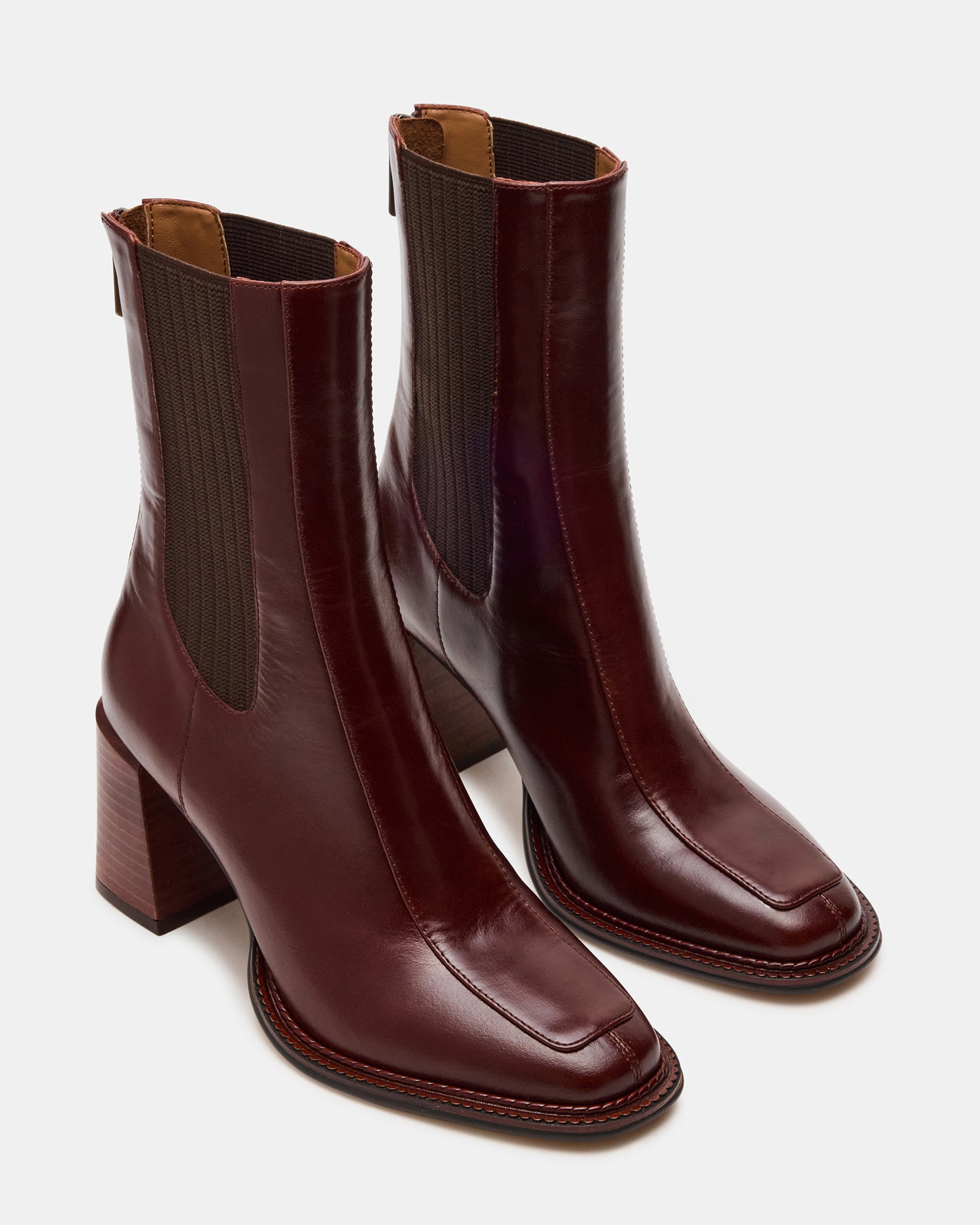 Side profile of womens brown leather boots paired with denim for casual downtown style