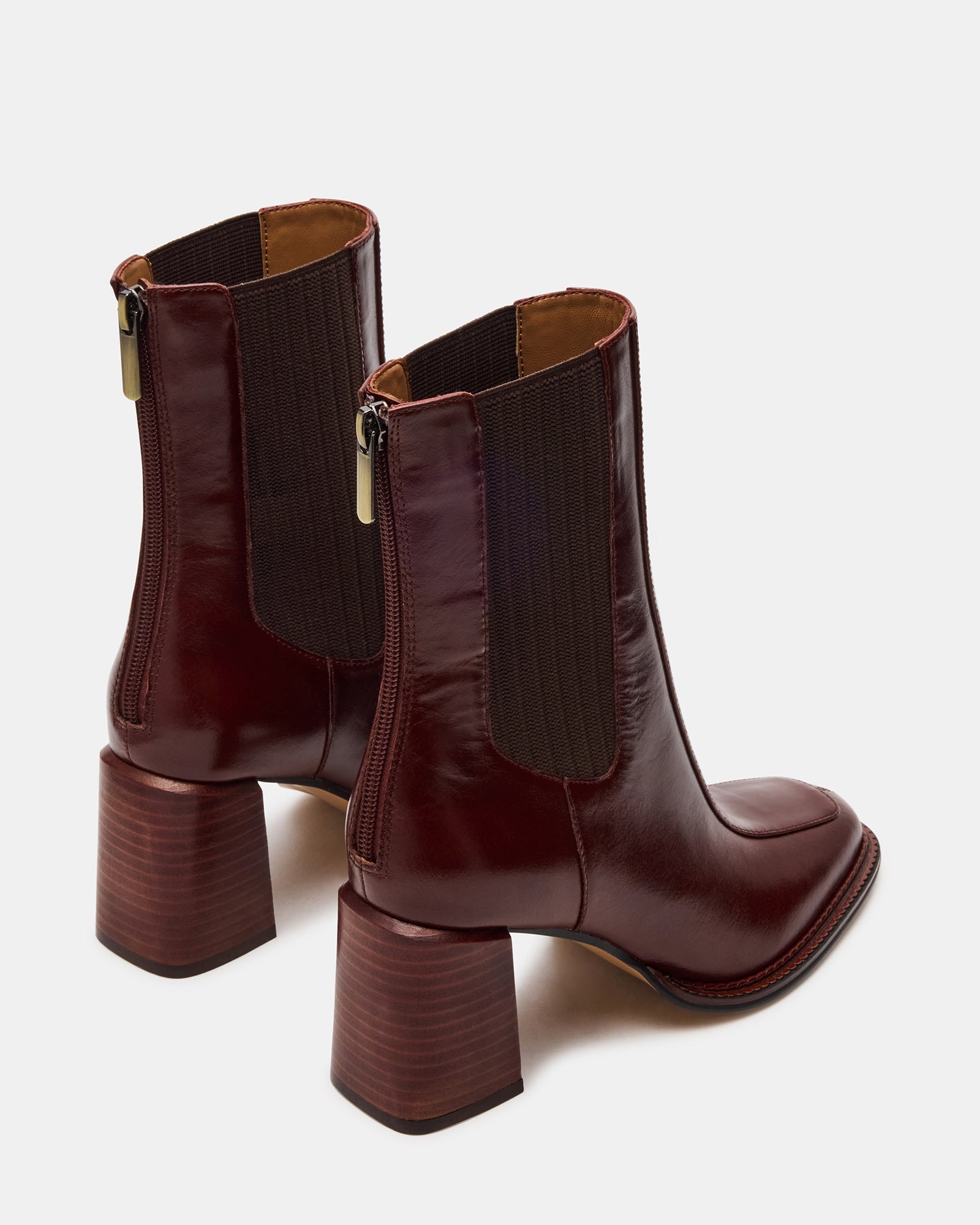 Side profile of womens brown leather boots paired with denim for casual downtown style