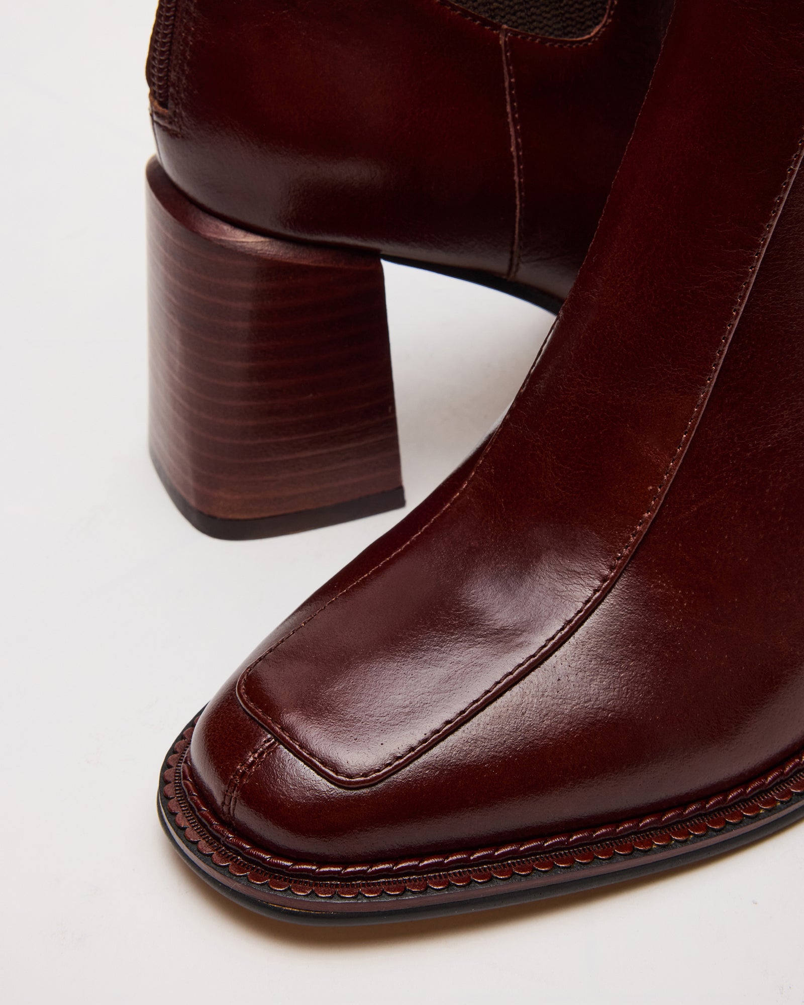 Back view of leather brown boots highlighting shaft height and synthetic sole