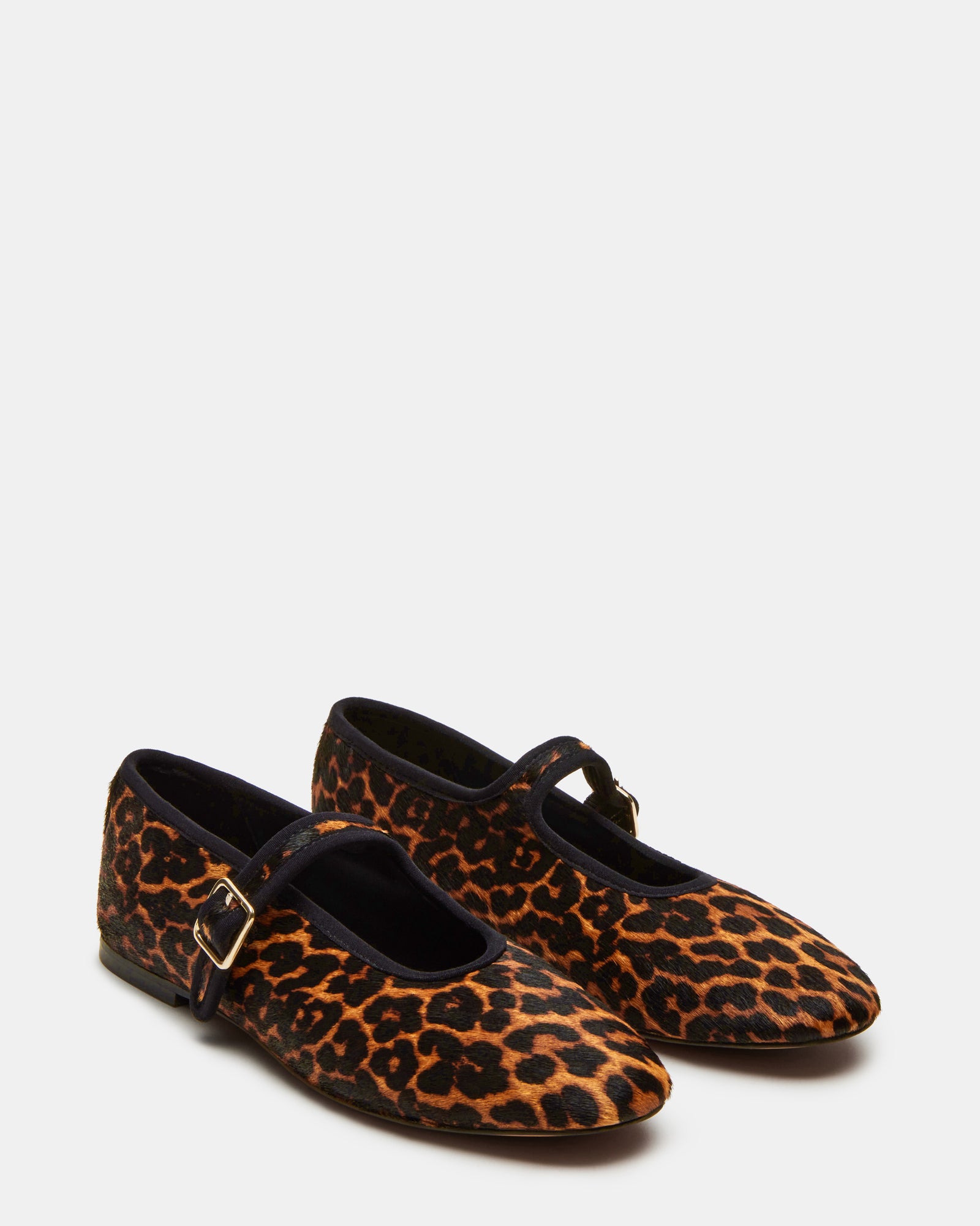 Woman wearing black ballet flats walking in city setting