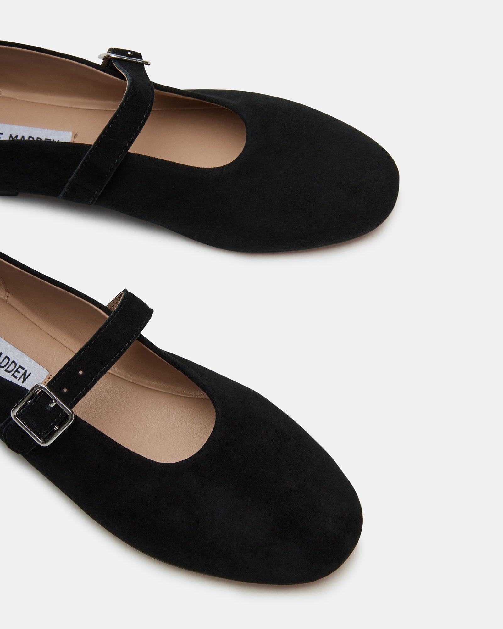 Close-up of black suede mary jane ballet flats showcasing the elegant design.