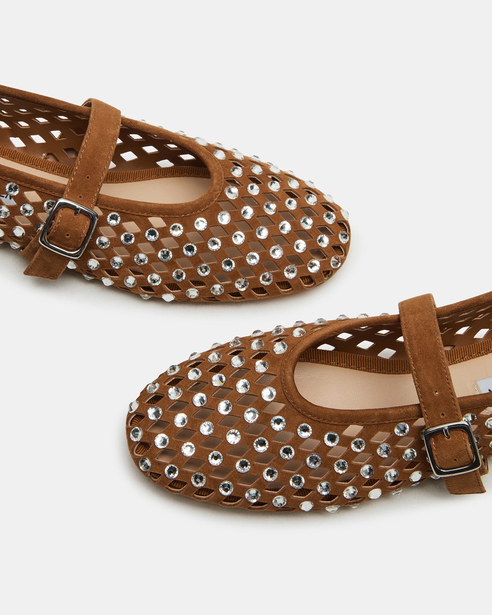 Close-up of brown suede flats showing rhinestone detailing and Mary Jane strap