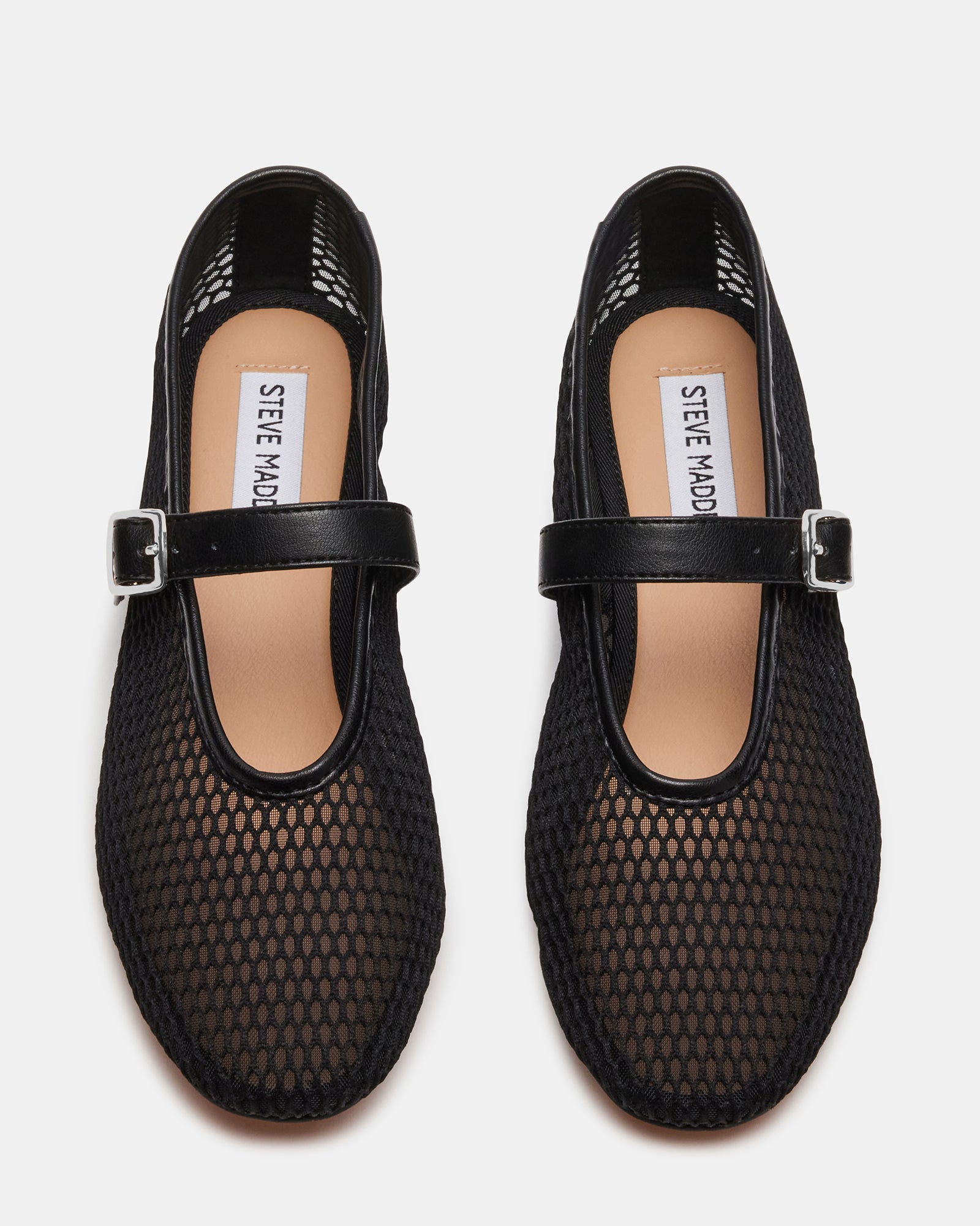 Front view of vegan ballet flats on a wooden floor, highlighting the textured upper.