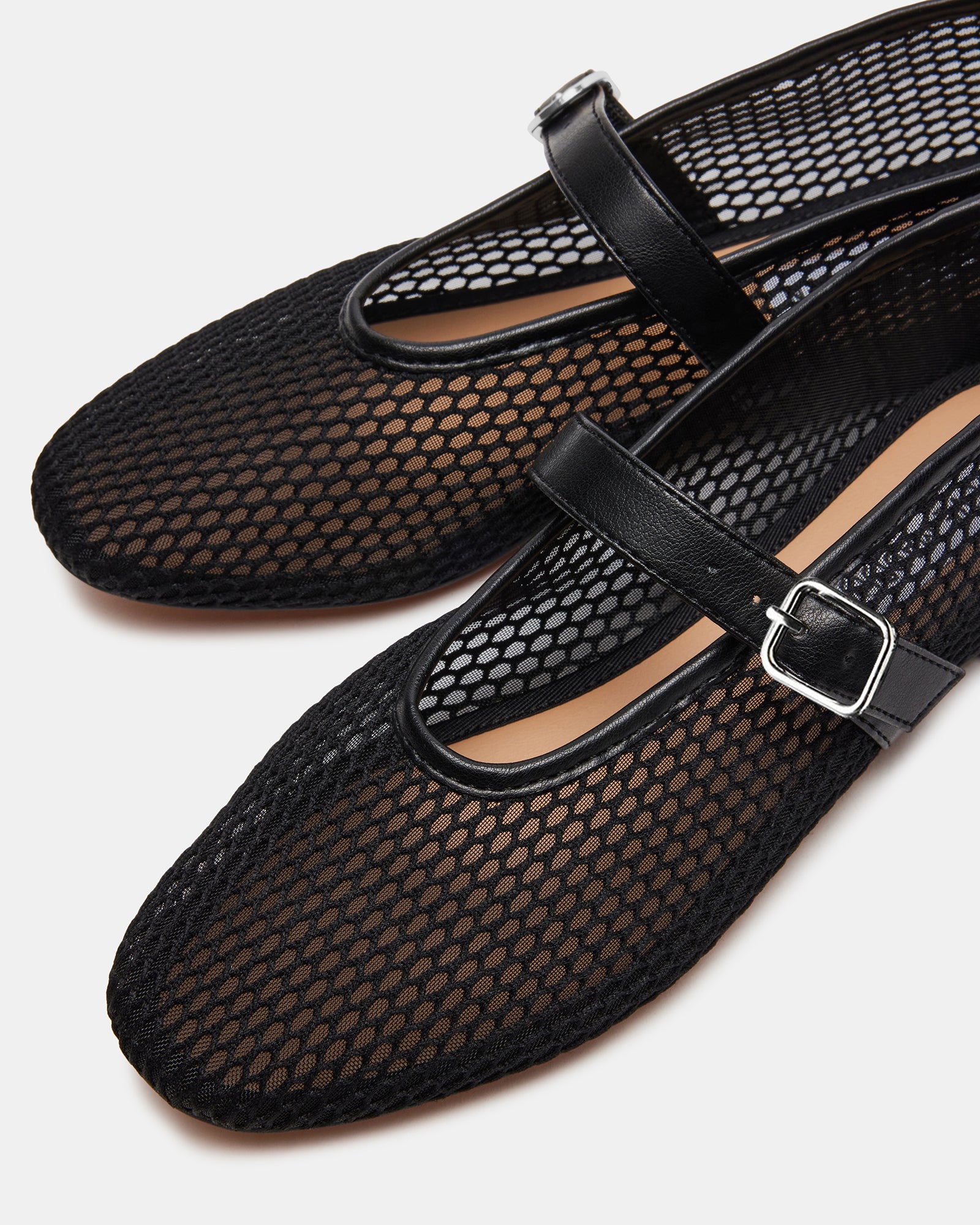 Black ballet flats from a side angle, showcasing the Mary Jane strap and mesh detail.