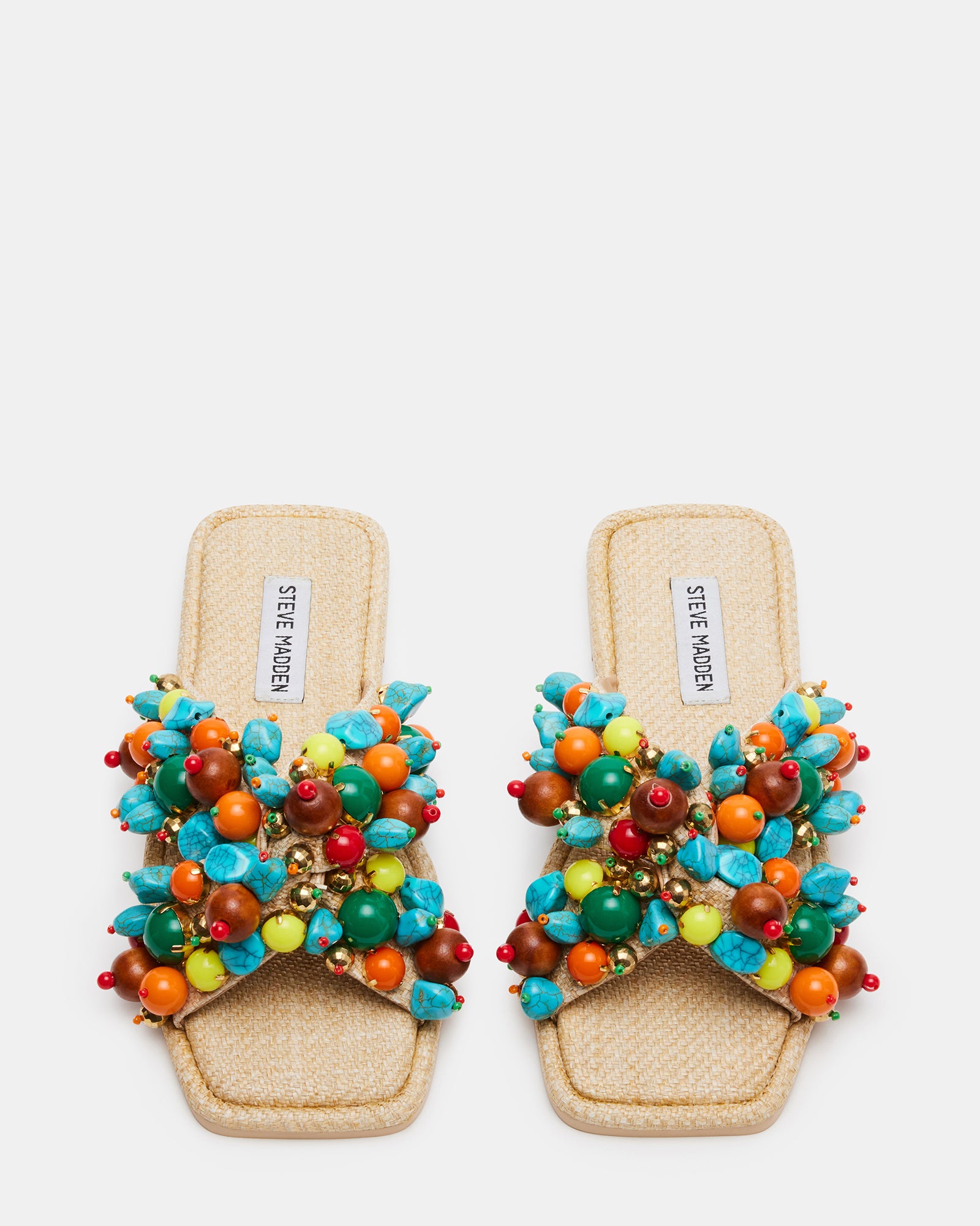 Side angle highlighting the low heel and slip-on style of the embellished sandals