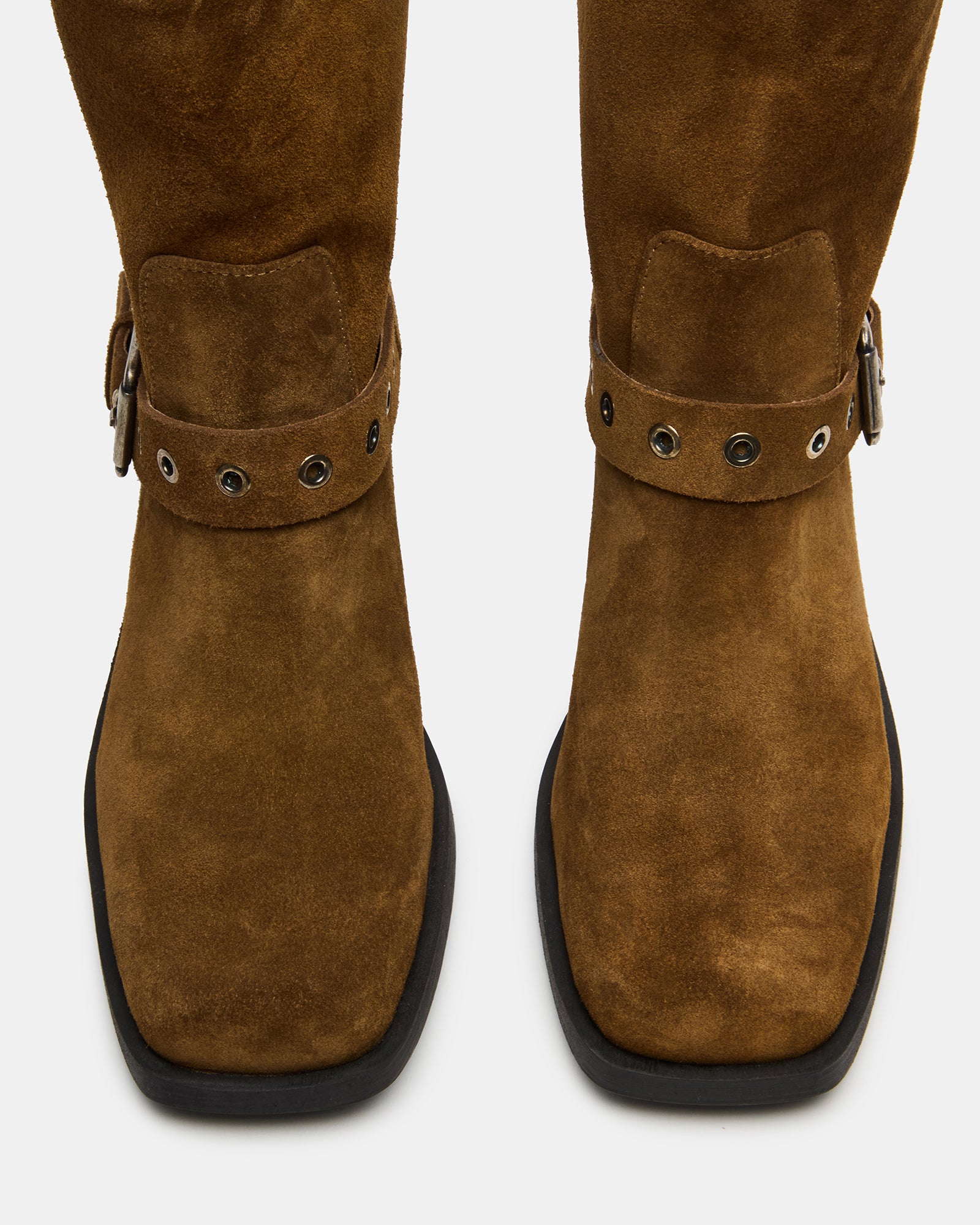 Tan suede moto boots for women styled with jeans